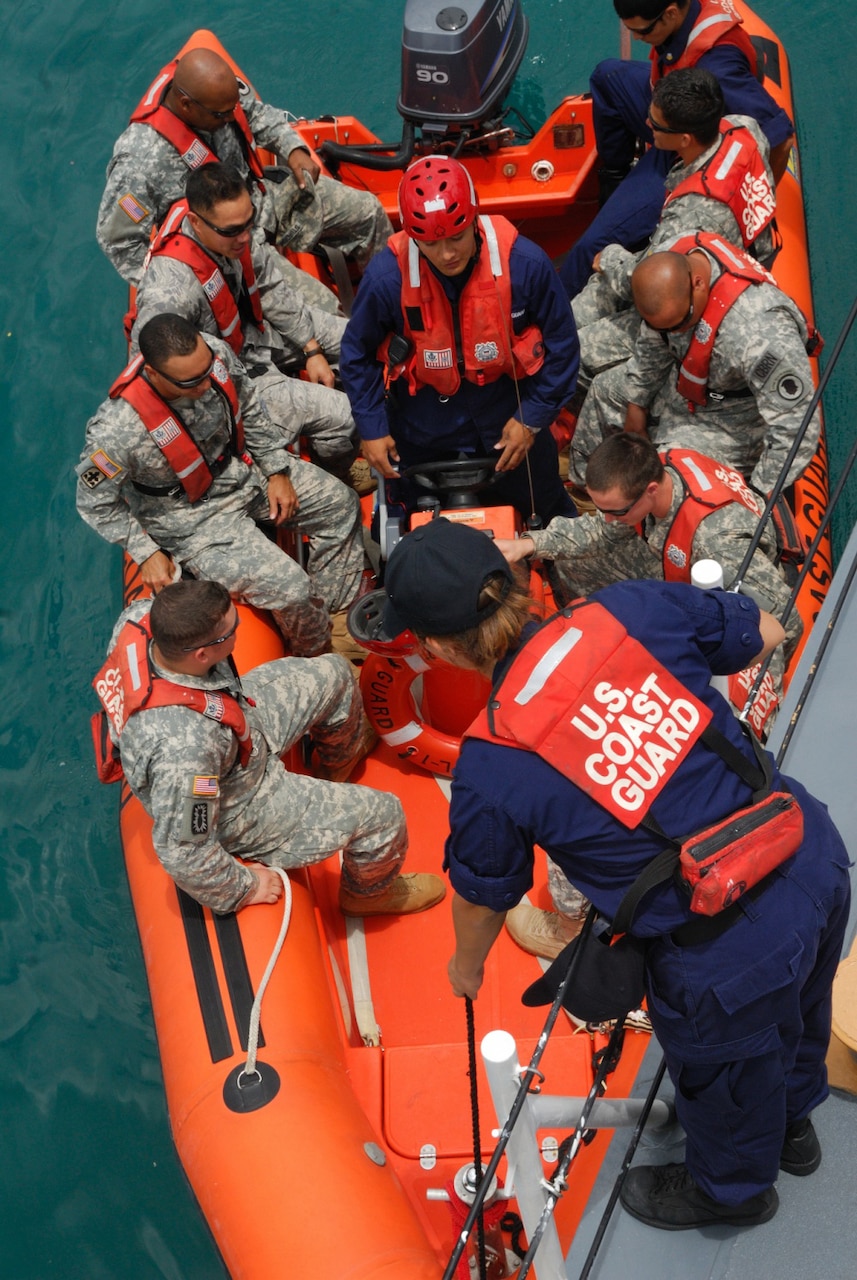 National Guard members board a boat during an exercise.
