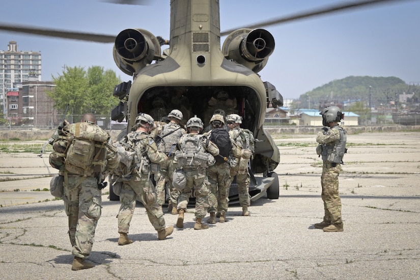 Soldiers board a CH-47 Chinook helicopter.