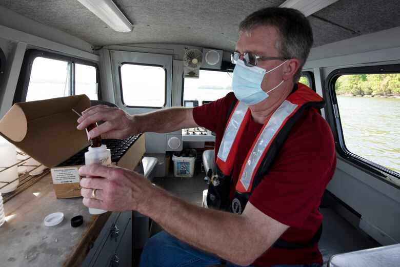 Mark Campbell, hydrologist in the U.S. Army Corps of Engineers Nashville District’s Water Management Section, puts a preservative into a chlorophyl sampling on a survey boat in J. Percy Priest Lake in Nashville Tennessee April 27, 2021. (USACE Photo by Lee Roberts)