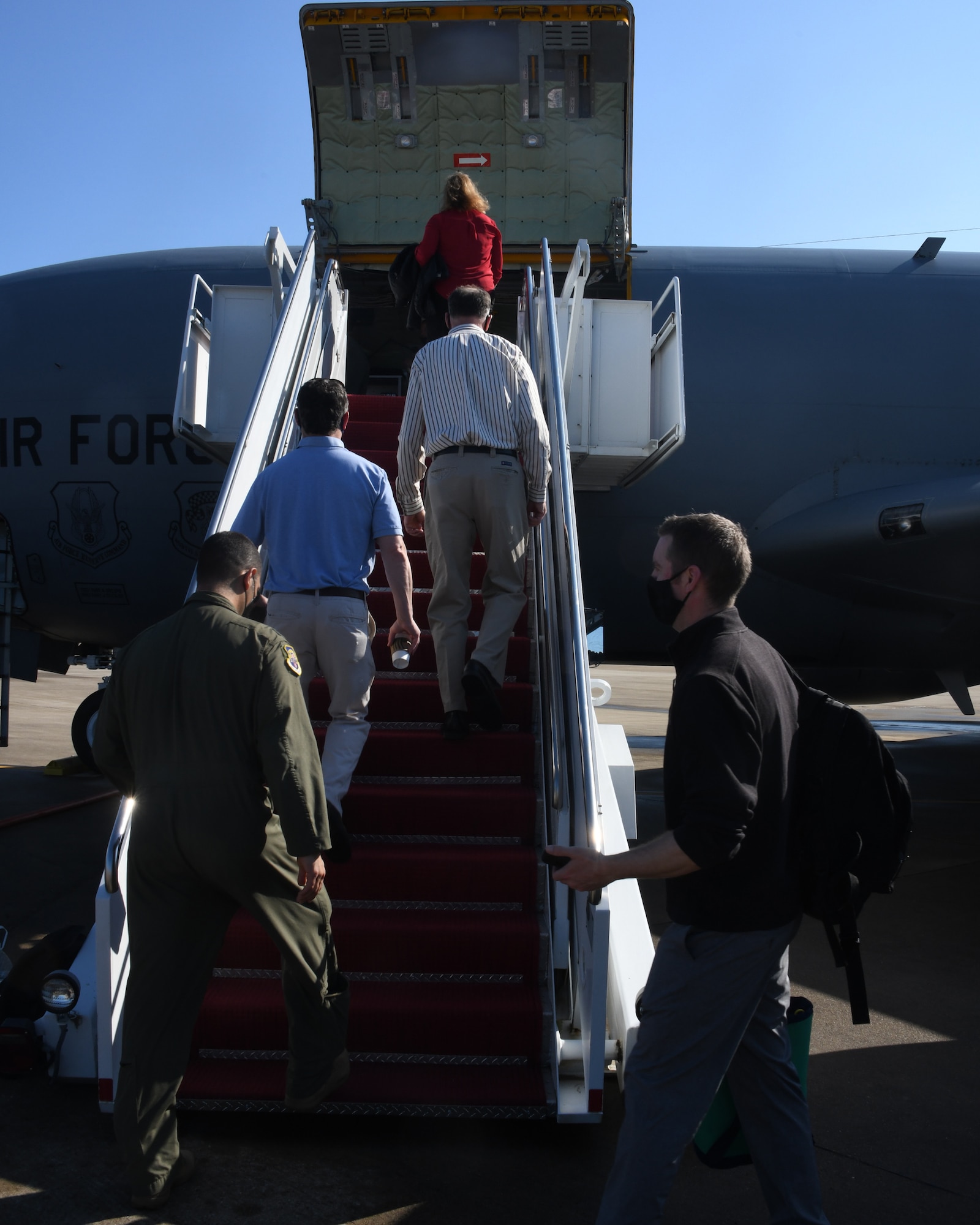 Congressional staff members from the House Armed Services Committee climb aboard a KC-135 Stratotanker in preparation for an air refueling mission with the 756th Air Refueling Squadron, May 4, 2021, at Joint Base Andrews, Md. The congressional staff members visited the wing to observe an air refueling mission with an E-8C Joint STARS aircraft. (U.S. Air Force photo by Staff Sgt. Cierra Presentado/Released)