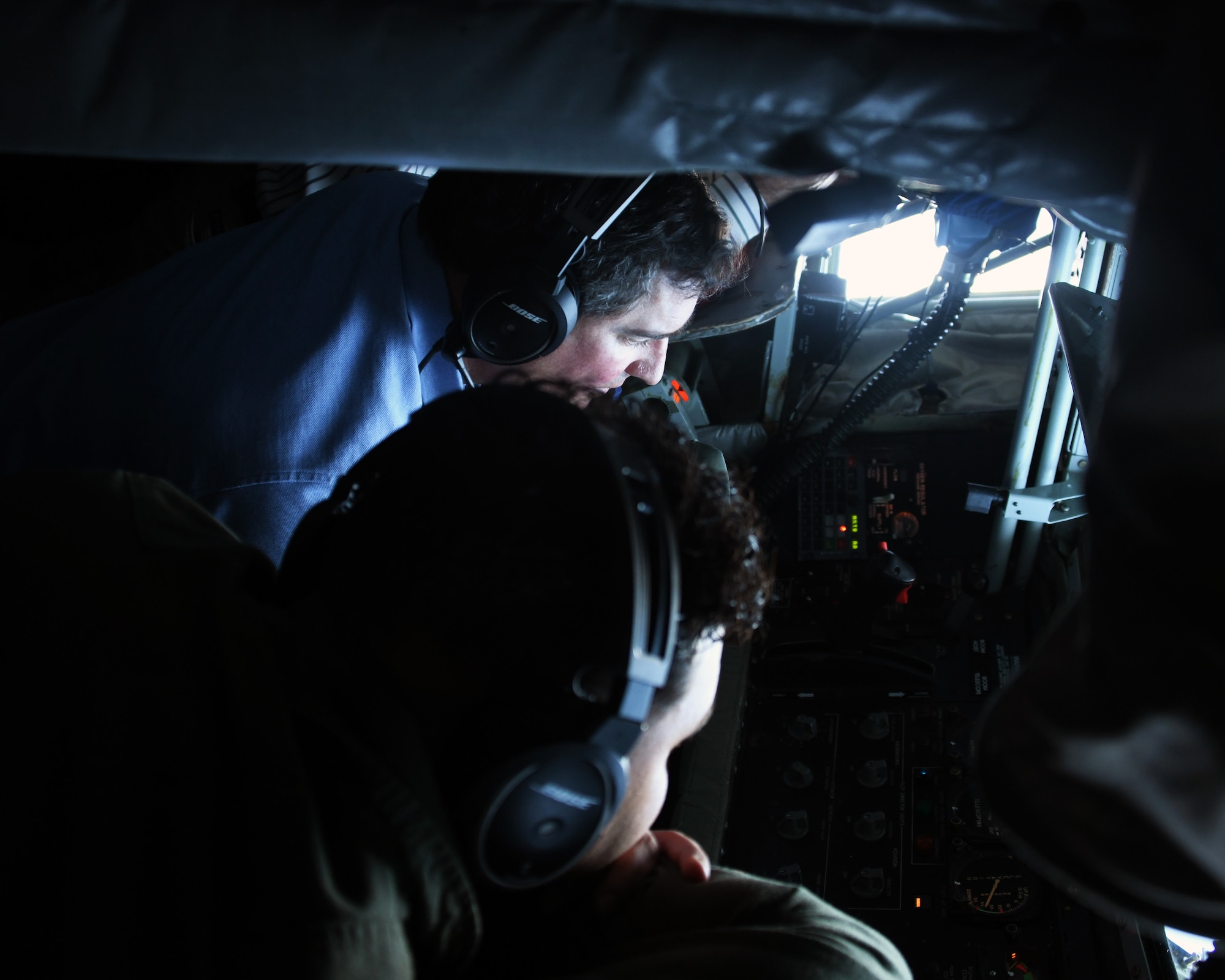 Congressional staff member Phil MacNaughton lays next to Tech. Sgt. Mark Simmons, 756th Air Refueling Squadron boom operator, as he demonstrates how to operate the boom during flight May 4, 2021, out of Joint Base Andrews, Md. The congressional staff members visited the wing to observe an air refueling mission with an E-8C Joint STARS aircraft. (U.S. Air Force photo by Staff Sgt. Cierra Presentado/Released)