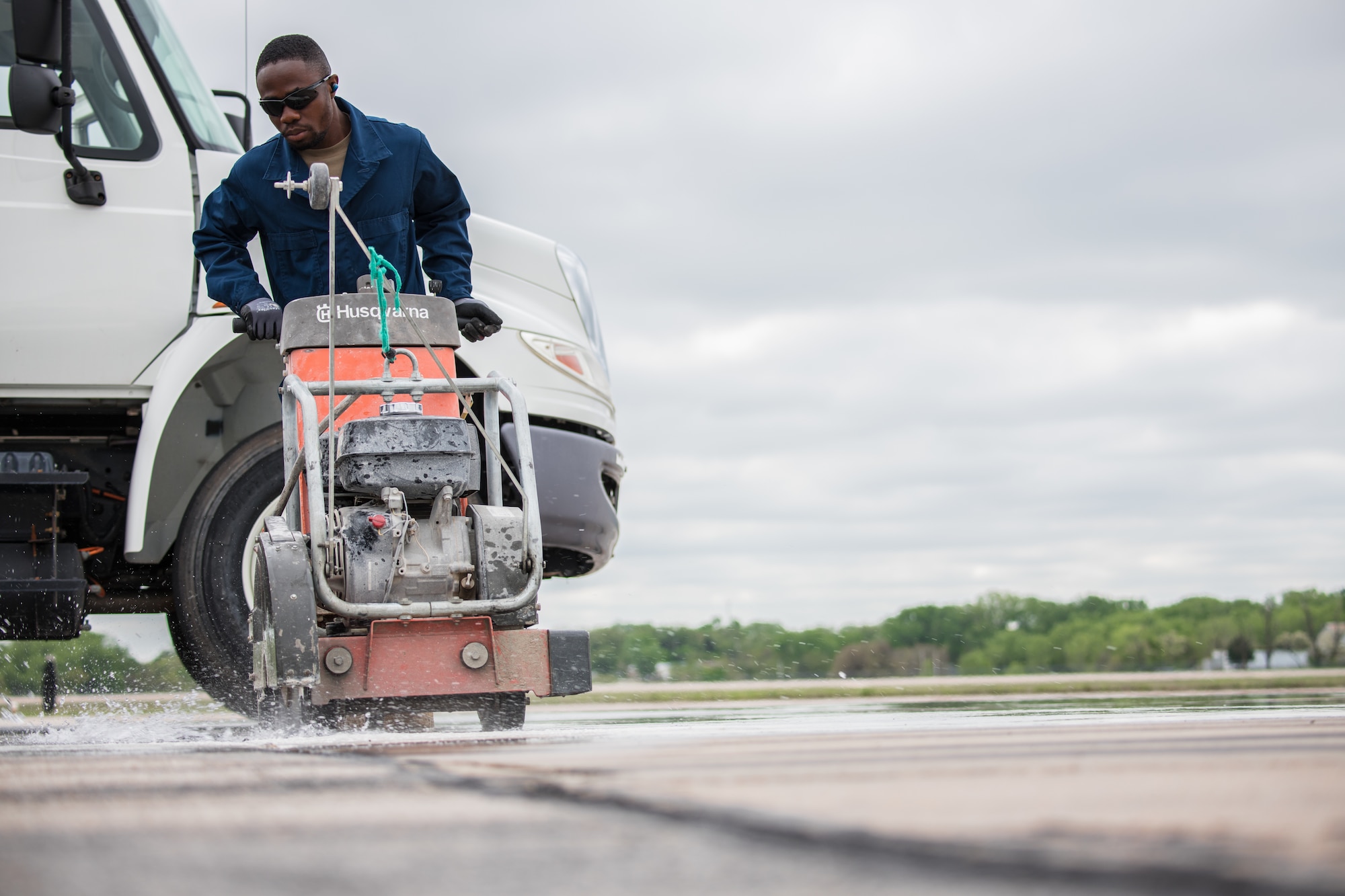 Airman 1st Class Bismark Berchie, 22nd Civil Engineer Squadron pavement and heavy machinery journeyman, uses a saw during a spall repair on the flightline May 3, 2021, at McConnell Air Force Base, Kansas. Airfield repair Airmen are on standby to restore any flightline faults in case of an emergency. (U.S. Air Force photo by Senior Airman Alan Ricker)