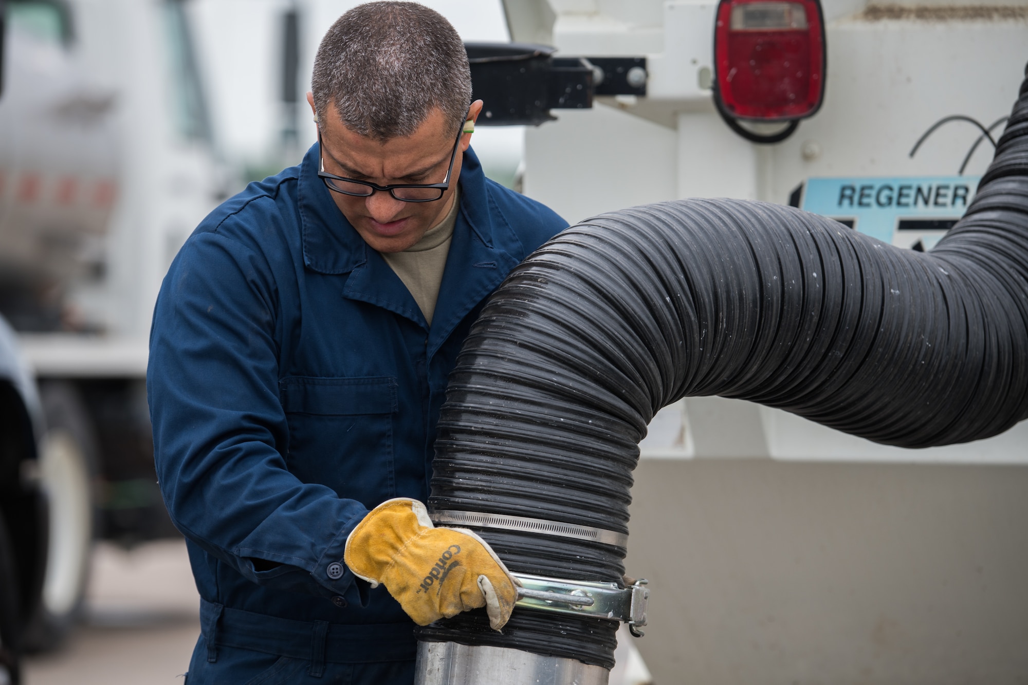 Airman 1st Class Rafael Machado, 22nd Civil Engineer Squadron pavement and heavy machinery journeyman, vacuums broken cement during a spall repair May 3, 2021, at McConnell Air Force Base, Kansas. The repair is a multi-staged process that allows use of an airfield to be quickly reestablished. (U.S. Air Force photo by Senior Airman Alan Ricker)