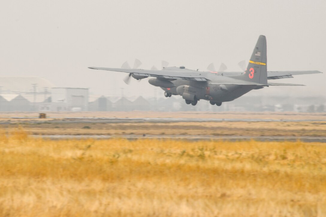 A plane takes off into smoke-shrouded sky.