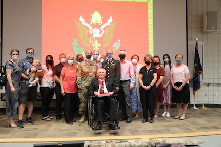 Man in wheelchair poses with family members