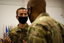 U.S. Air Force Staff Sgt. Nathan Smith, 54th Airlift Squadron flight attendant, briefs Air Force Chief of Staff Gen. Charles Q. Brown, Jr., on Scott Air Force Base, Illinois, April 28, 2021. The Scott AFB Honor Guard is the third busiest Air Force Honor Guard in the United States, and they showcased to Brown how they utilize and train their Airmen. (U.S. Air Force photo by Airman 1st Class Isaac Olivera)