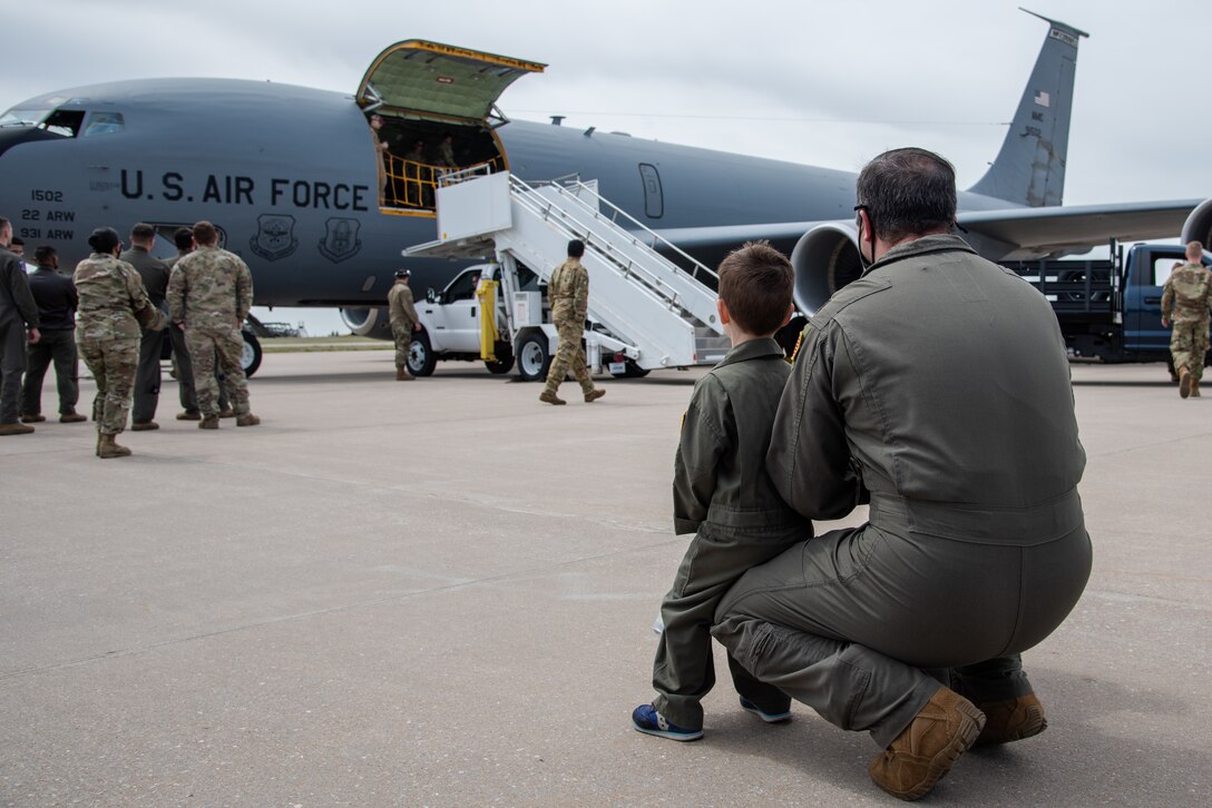 Maj. Jonathan Bergkamp, 22nd Wing Staff Agencies command post chief, and his children wait to greet his wife Lt. Col Sara Berkgamp, 349th Air Refueling Squadron director of operations, April 13, 2021, at McConnell Air Force Base, Kansas. While deployed, the team stood up temporary operations in Jeddah, Saudi Arabia, as part of a U.S. Air Forces Central Agile Combat Employment capstone event, marking the first tanker deployment to the location in 30 years. 
 (U.S. Air Force photo by Airman 1st Class Zachary Willis)