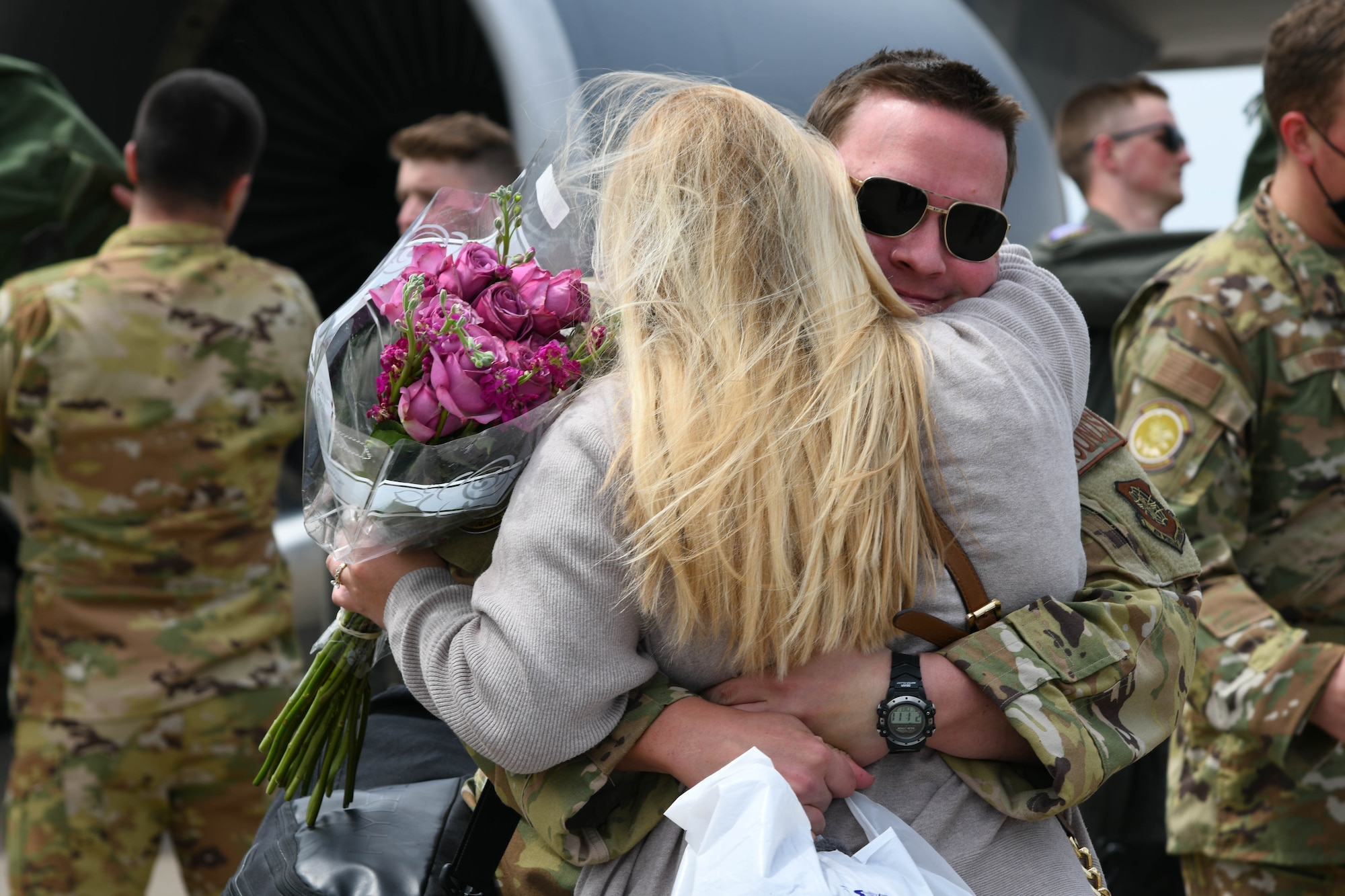 Capt. Micah Newmann, 350th Air Refueling Squadron pilot, hugs his wife Marie Newmann after returning home from deployment April 13, 2021, at McConnell Air Force Base, Kansas. After a demanding yet successful deployment, the Falcons were happy to return home to Team McConnell and their loved ones. (U.S. Air Force photo by Senior Airman Nilsa Garcia)