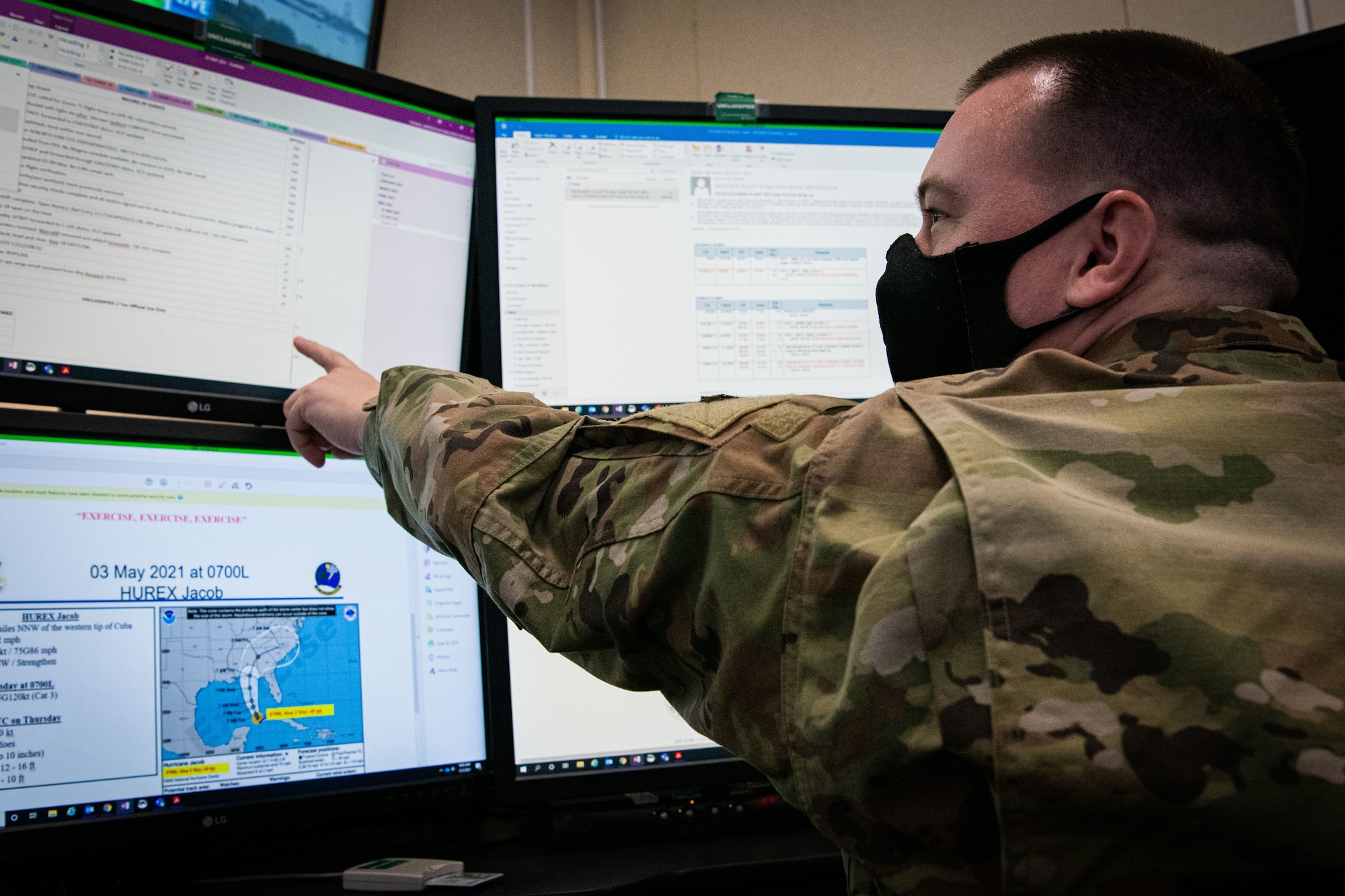 Airman points at screen.