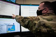 Airman points at screen.