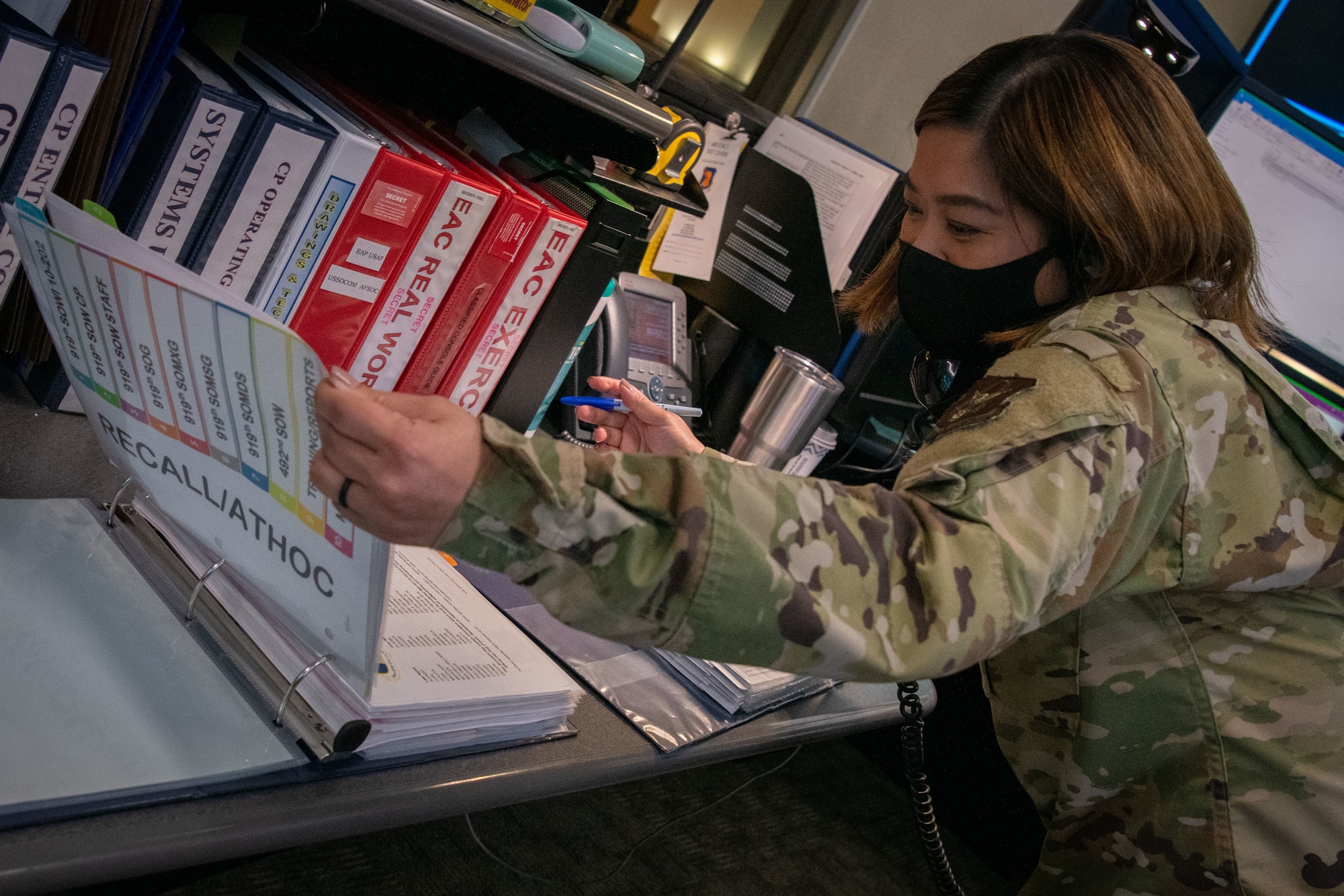 Airman opens binder.