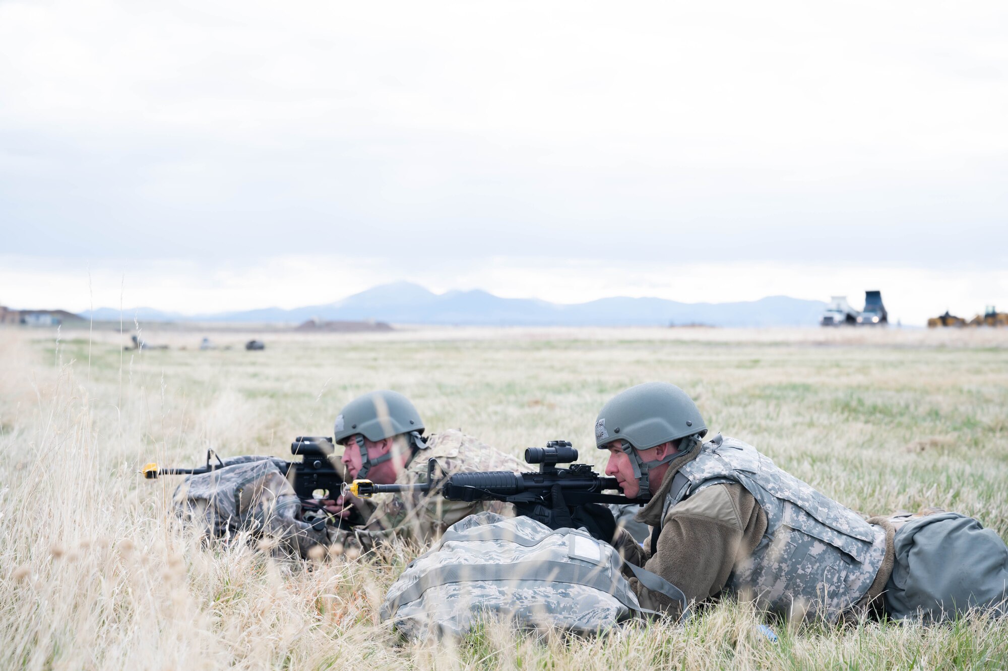 Senior Airman Terry Pittman and Airman Thomas Snow, 819th RED HORSE SQUADRON water and fuels system maintenance technicians, perform perimeter security during an exercise May 4, 2021, at Malmstrom Air Force Base, Mont.
