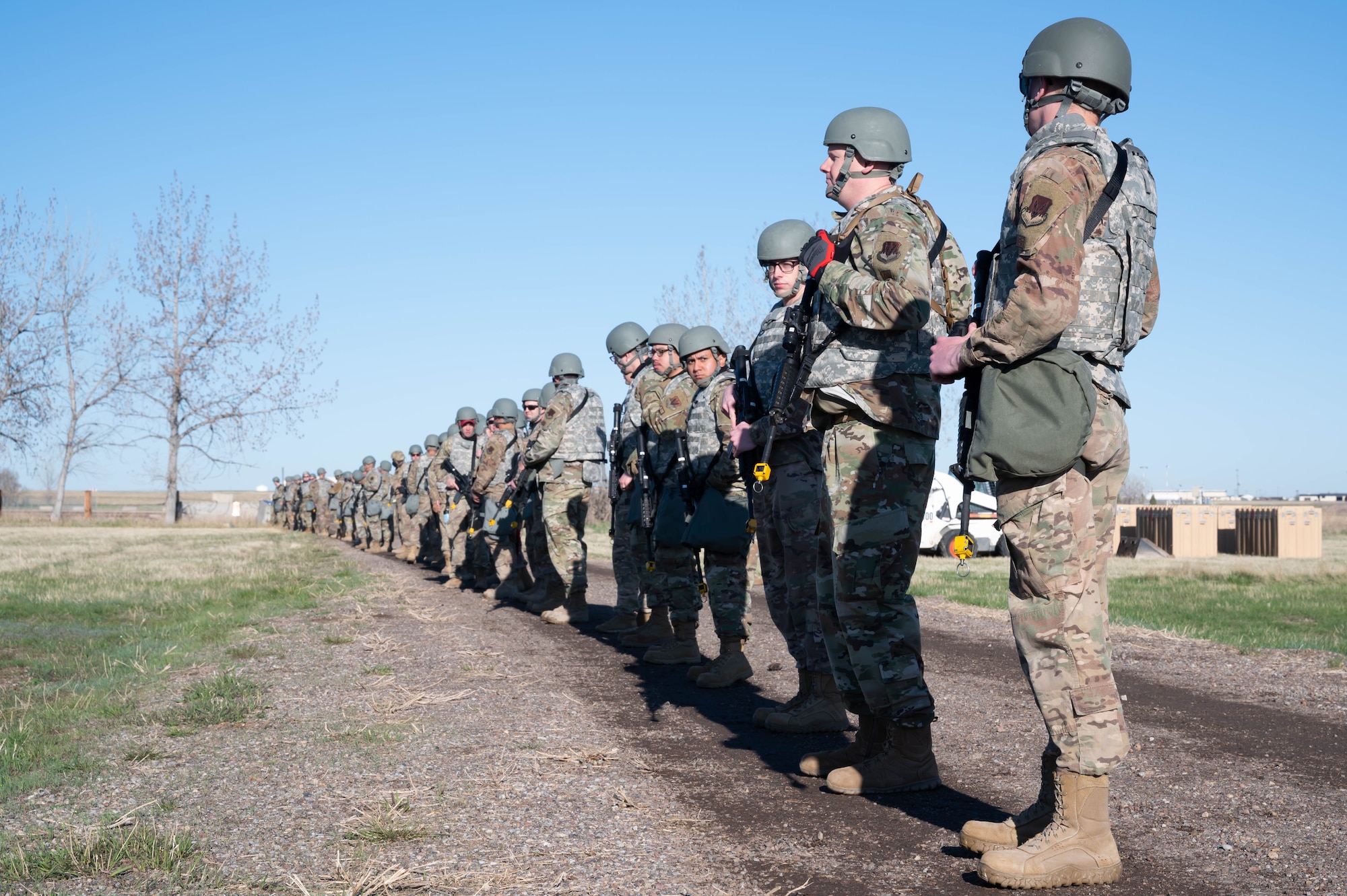 Airmen from the 819th RED HORSE Squadron prepare to perform a security sweep of the area to check for hazards during an exercise May 3, 2021, at Malmstrom Air Force Base, Mont.
