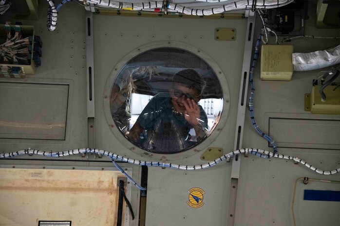 a child looks out of a window.
