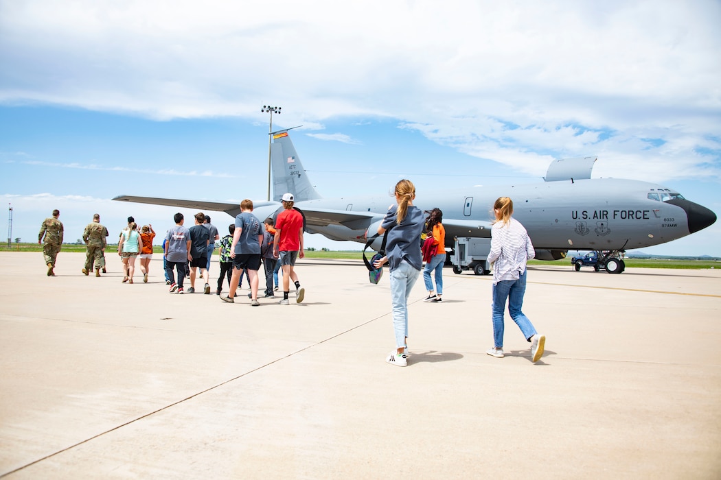 people walk past an aircraft