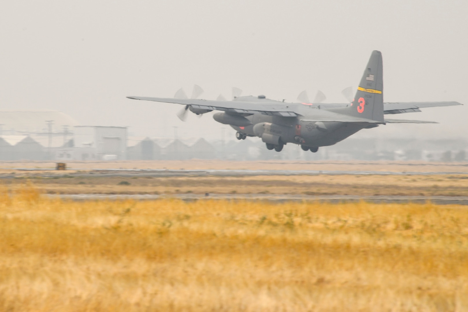 A U.S. Air National Guard C-130H Hercules from the 153rd Airlift wing out of Wyoming, takes off to attack the LNU Lightning Complex Fire from McClellan Air Park, California, 21 Aug., 2020. C-130s equipped with Modular Airborne Firefighting System II from Wyoming and California are working side-by-side with other fire fighting aircraft to tackle various fires throughout Northern California.