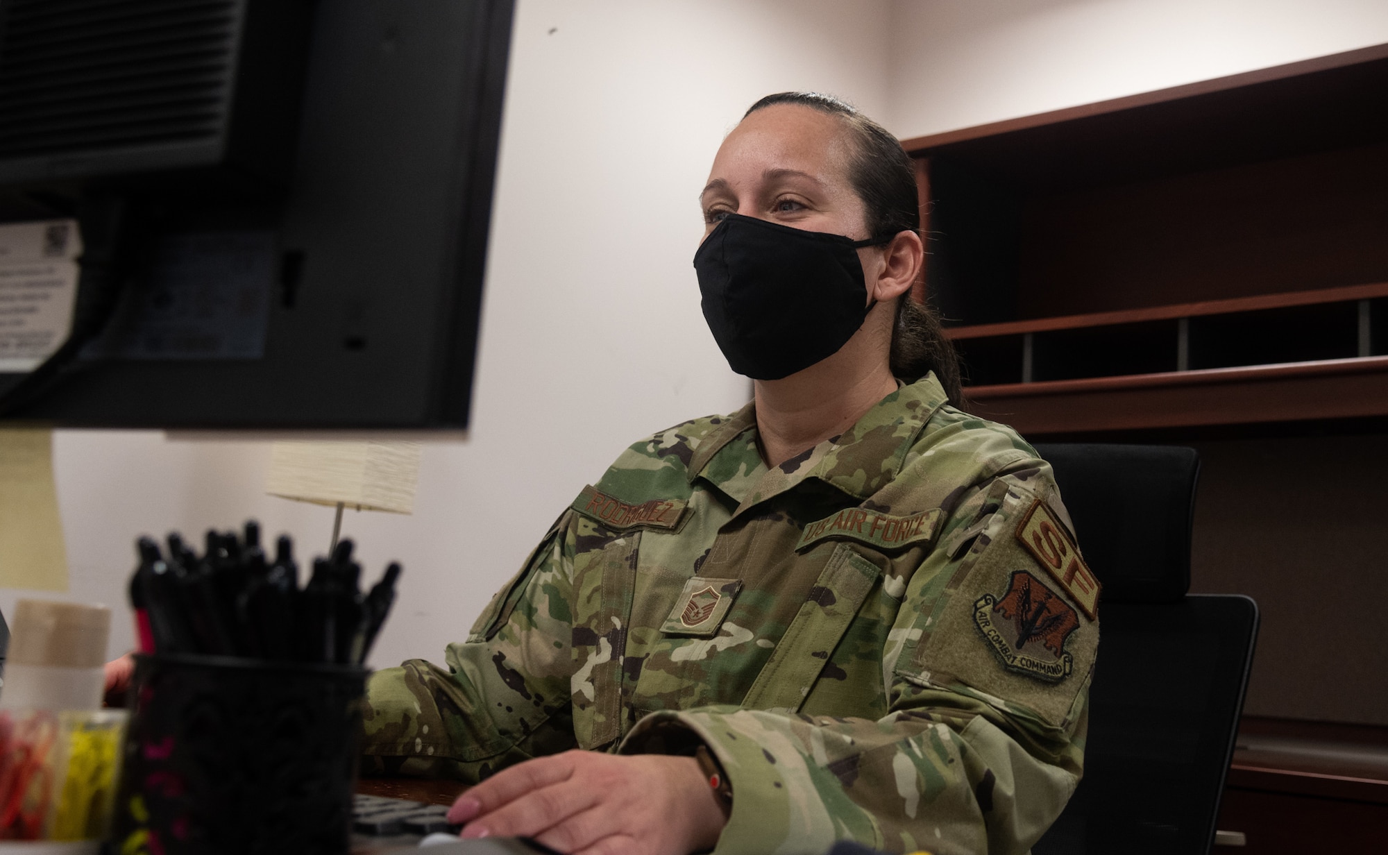 U.S. Air Force Master Sgt. Wanda Rodriguez, 175th Security Forces superintendent, sits at her desk in her office reviewing Air Force Instructions at Warfield Air National Guard Base at Martin State Airport, Middle River, Md., on March 5th, 2021.