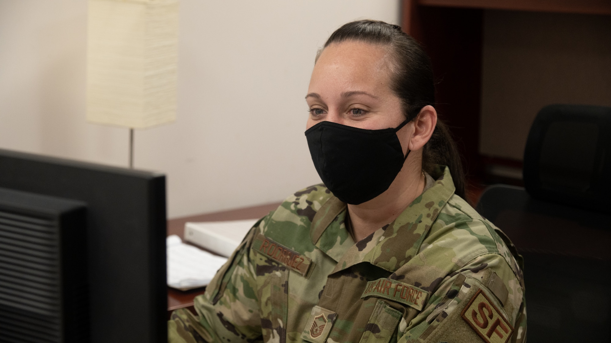 U.S. Air Force Master Sgt. Wanda Rodriguez, 175th Security Forces superintendent, sits at her desk in her office reviewing Air Force Instructions at Warfield Air National Guard Base at Martin State Airport, Middle River, Md., on March 5th, 2021.