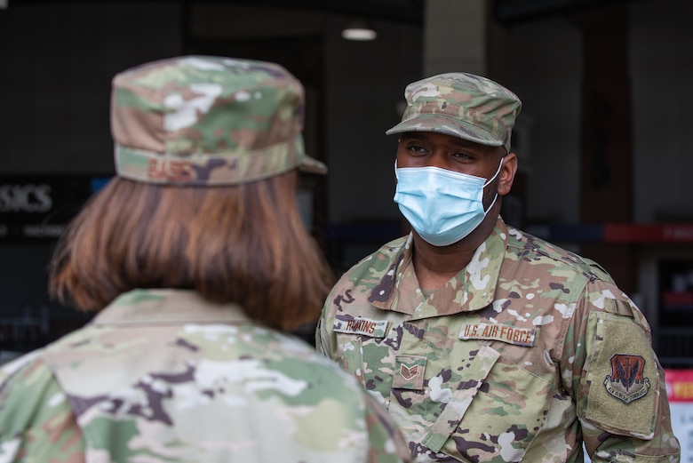 Chief Master Sgt. of the Air Force JoAnne S. Bass, speaks to Staff Sgt. Tavon Hawkins, an air transportation specialist assigned to the 175th Logistical Readiness Squadron, 175th Wing, while visiting the mass vaccination site at M&T Bank Stadium, Baltimore, on May 3, 2021.