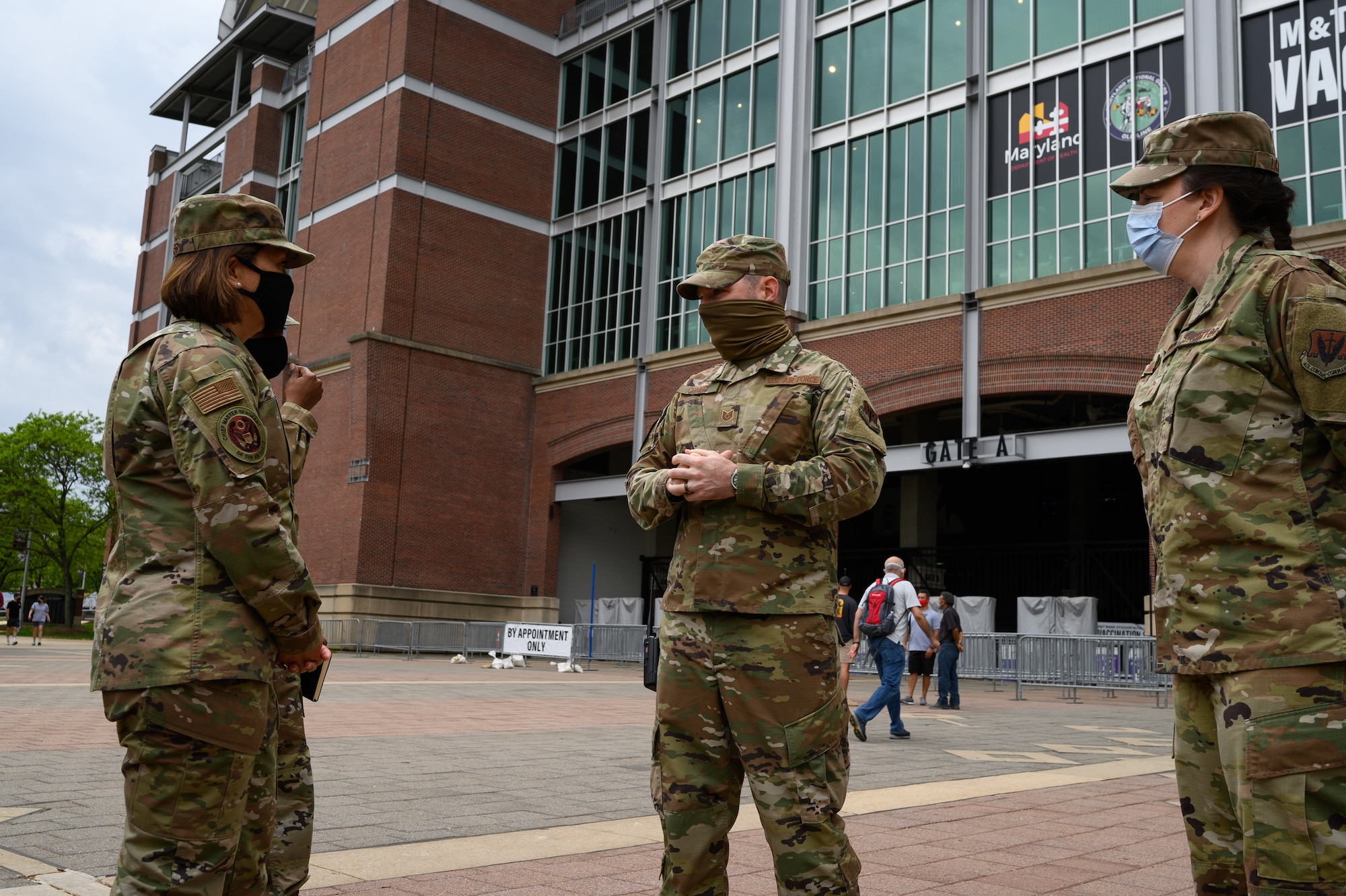 Chief Master Sgt. of the Air Force JoAnne S. Bass speaks to Tech. Sgt. Stephen Conkey, an aircrew flight equipment technician assigned to the 175th Operations Support Squadron, while visiting the mass vaccination site at M&T Bank Stadium, Baltimore, on May 3, 2021.