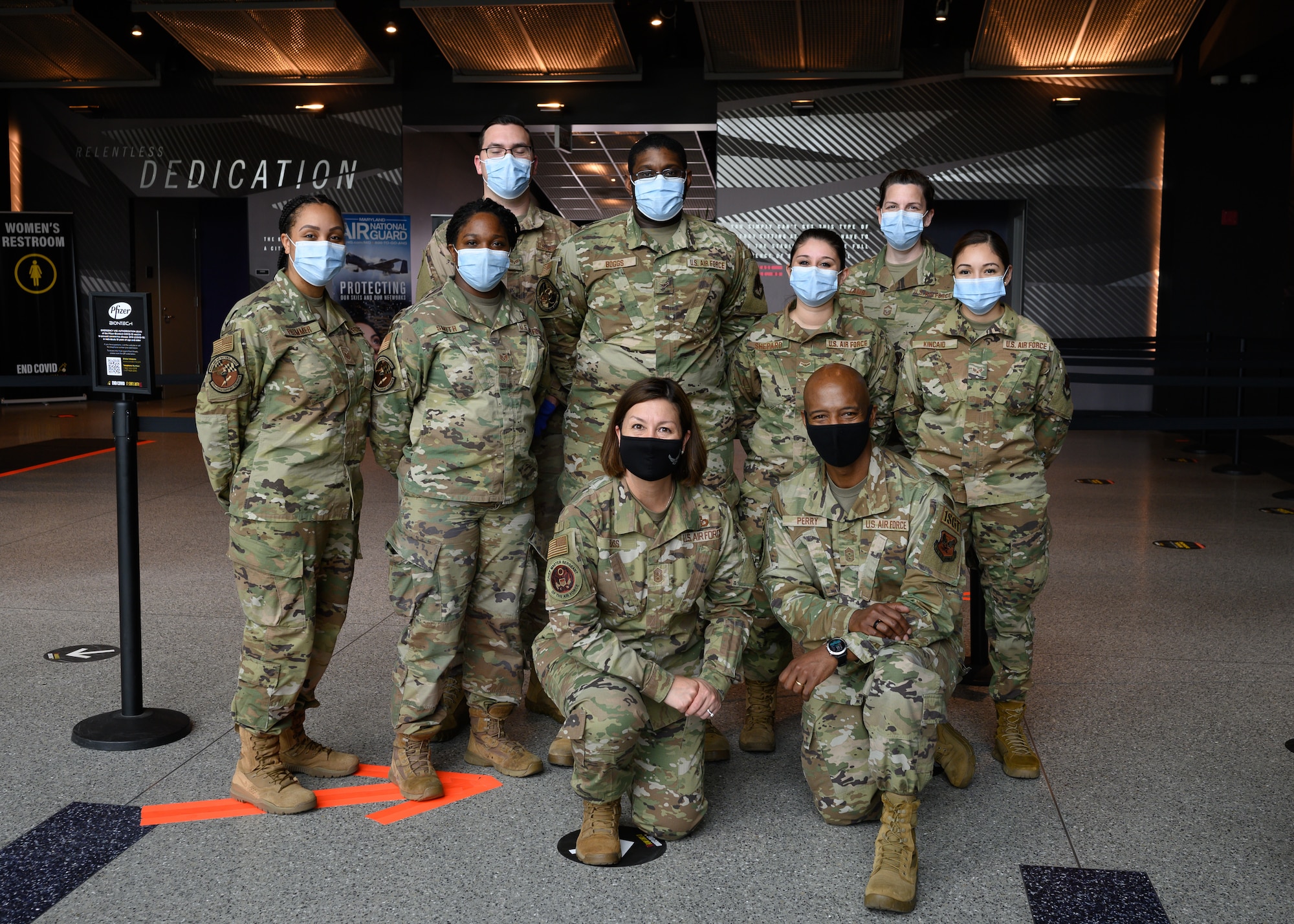 Chief Master Sgt. of the Air Force JoAnne S. Bass poses for a group portrait with Airmen assigned to the 175th Wing, Maryland National Guard, at the mass vaccination site at M&T Bank Stadium, Baltimore, on May 3, 2021.