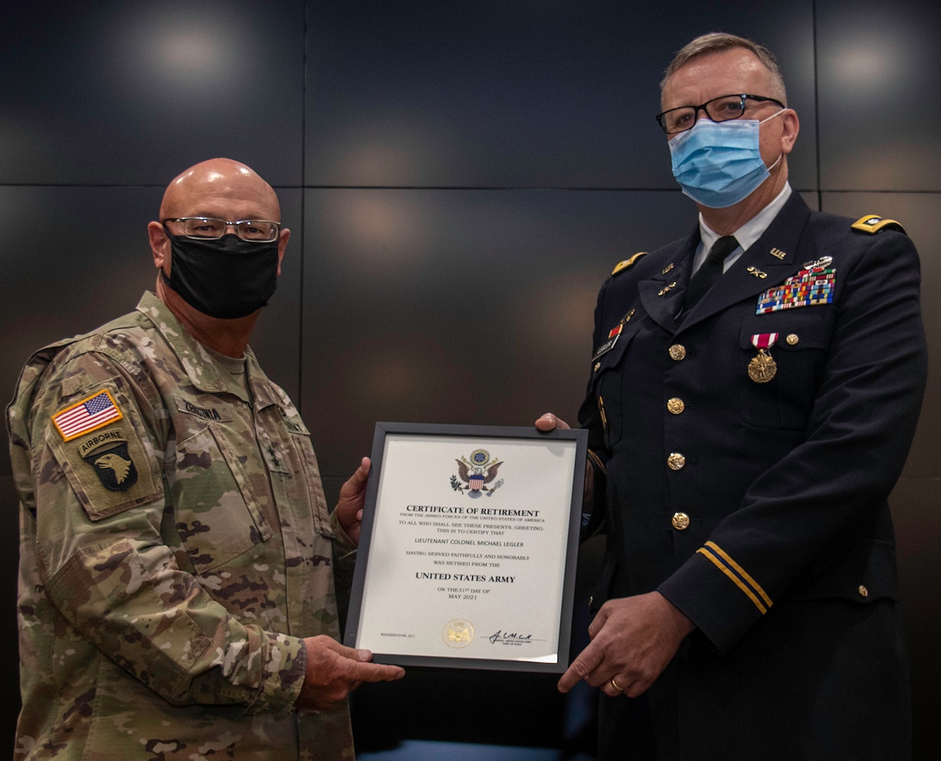 Illinois Army National Guard Lt. Col. Michael Legler (right), of Pekin, Illinois, receives a Certificate of Retirement from Maj. Gen. Michael Zerbonia, of Chatham, Illinois, Assistant Adjutant General – Army, during his retirement ceremony April 30 at the Illinois Military Academy, Camp Lincoln in Springfield, Illinois.