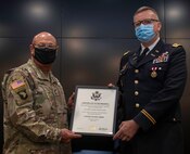 Illinois Army National Guard Lt. Col. Michael Legler (right), of Pekin, Illinois, receives a Certificate of Retirement from Maj. Gen. Michael Zerbonia, of Chatham, Illinois, Assistant Adjutant General – Army, during his retirement ceremony April 30 at the Illinois Military Academy, Camp Lincoln in Springfield, Illinois.