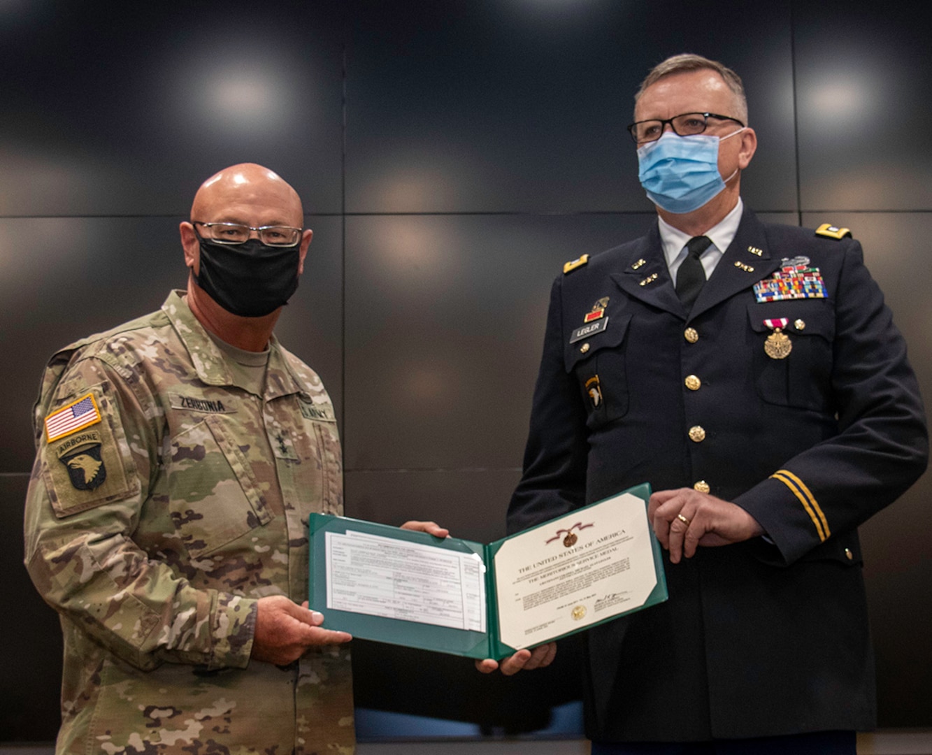 Illinois Army National Guard Lt. Col. Michael Legler (right), of Pekin, Illinois, receives the Meritorious Service Medal from Maj. Gen. Michael Zerbonia, of Chatham, Illinois, Assistant Adjutant General – Army, during his retirement ceremony April 30 at the Illinois Military Academy, Camp Lincoln in Springfield, Illinois.