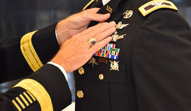 Col. Andrew R. “Drew” Morgan receives the Army astronaut device from Lt. Gen. Daniel L. Karbler, commanding general of U.S. Army Space and Missile Defense Command, during a May 5 ceremony at the National Museum of the United States Army at Fort Belvoir, Virginia. (Photo by Ronald Bailey)