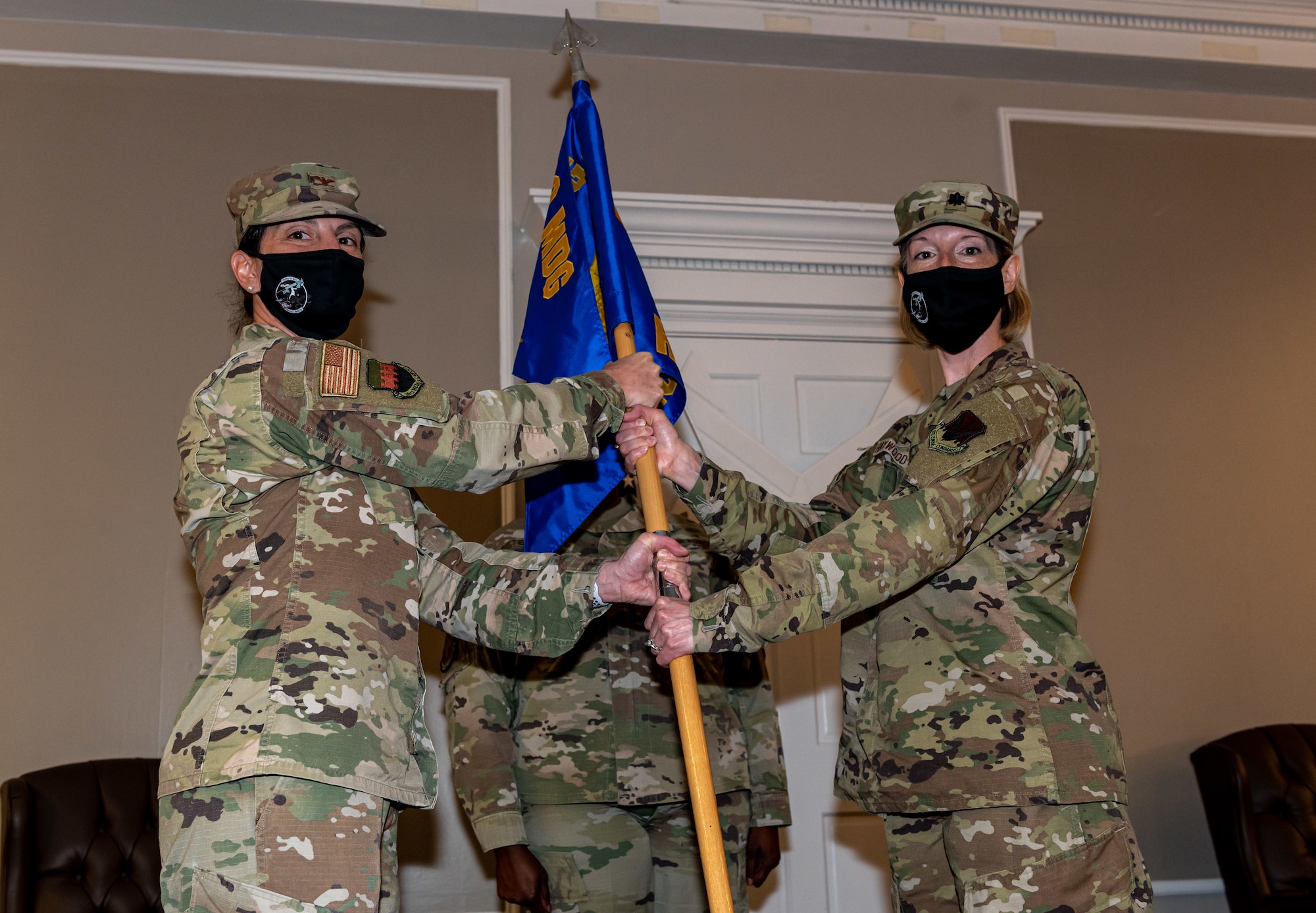 A photo of Airmen holding a flag.
