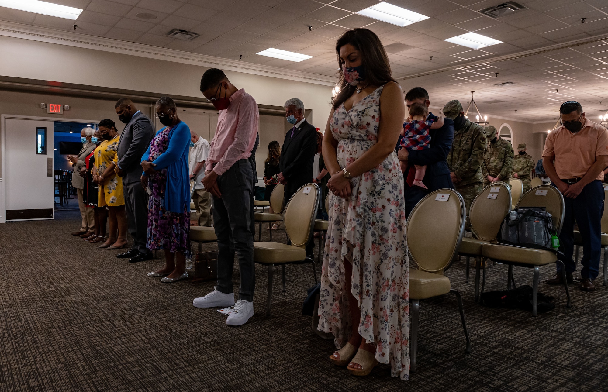 A photo of families bowing their head.