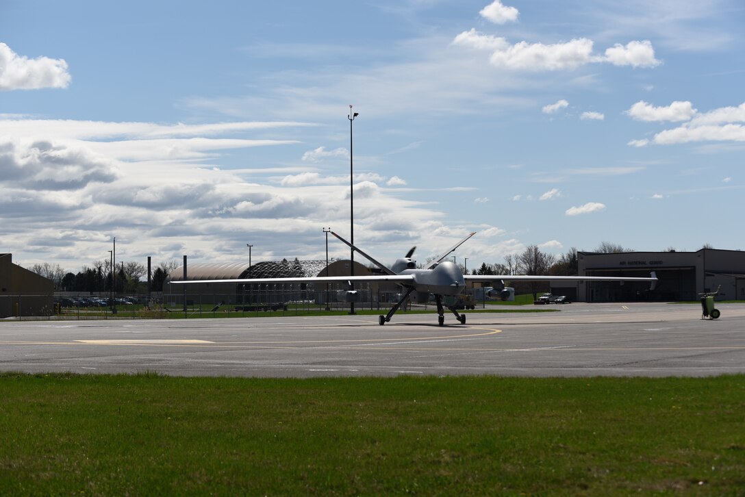 An MQ-9 Reaper with three Ghost Reaper pods attached awaits takeoff at Hancock Field Air National Guard Base, Syracuse, New York. Ghost Reaper pods will establish new and enhanced capabilities for the MQ-9 reaper. The pods will undergo operational assessments during Exercise Northern Edge in Fairbanks, Alaska. (U.S. Air National Guard photo by Staff Sgt. Megan Fowler)