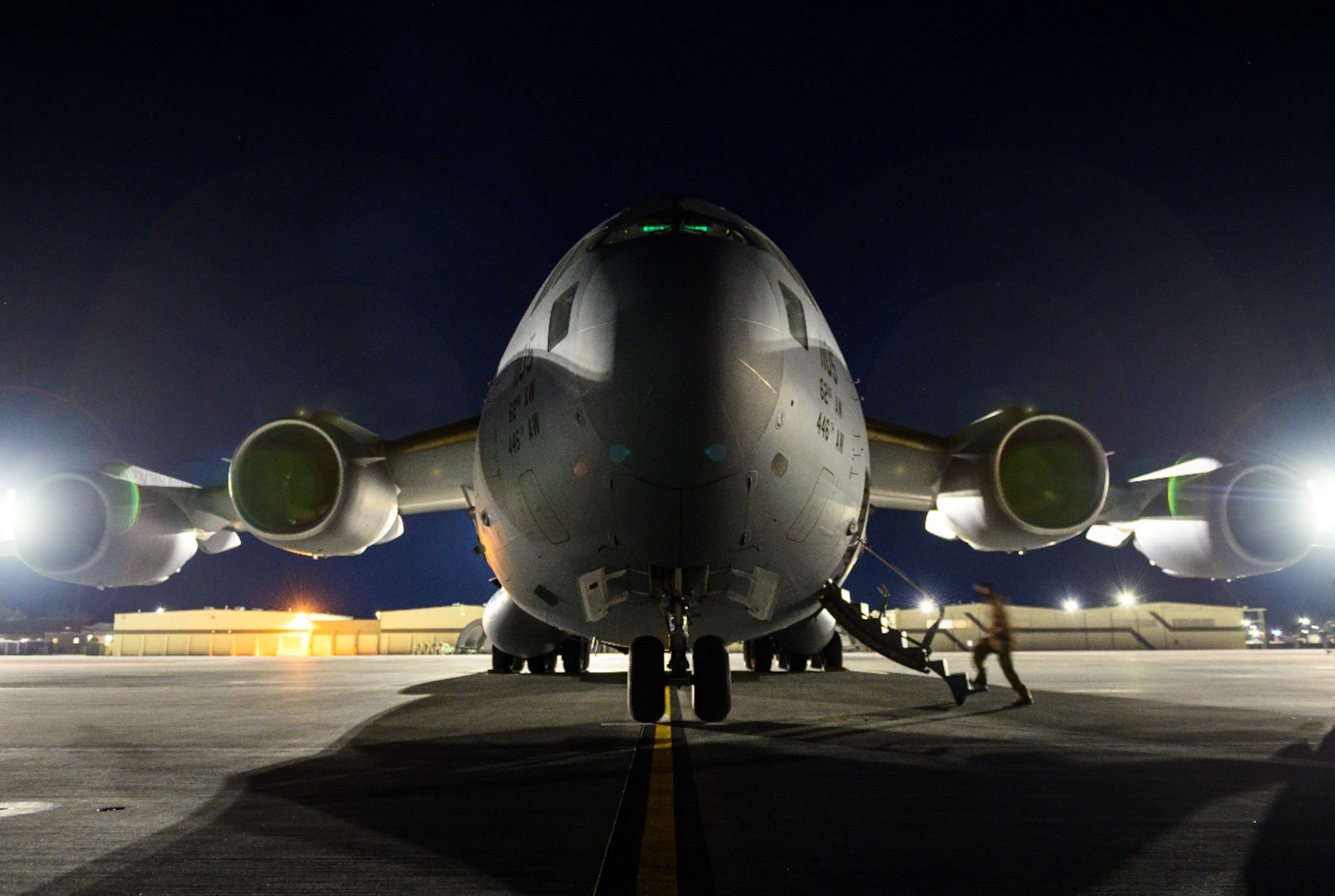 An Airman boards a C-17 Globemaster III from Joint Base Lewis-McChord, Washington, on the flight line at Mountain Home Air Force Base, Idaho, April 27, 2021. The C-17 played a prominent role in exercise Rainier War by ensuring prompt distribution of both defensive and offensive capabilities to simulated areas during the training.