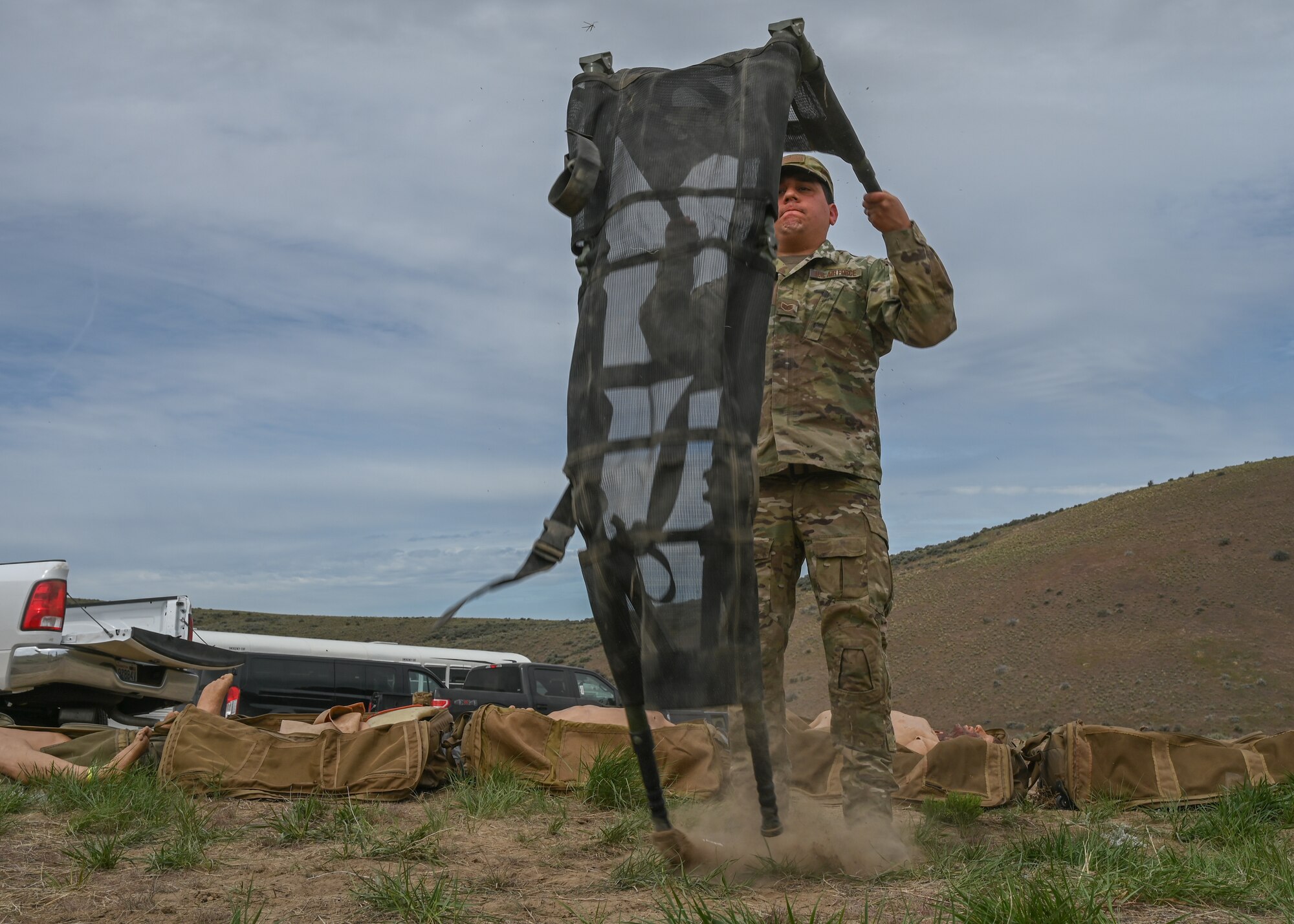 A U.S. Air Force tactical air control party Airman with the 5th Air Support Operations Squadron opens a skedco litter at Yakima Training Center, Washington, April 28, 2021. During the Over the course of their week-long field training exercise, TACP Airmen conducted various medical practices in order to meet changing tactical requirements and advance ground skill sets for varying mission requirements. (U.S. Air Force photo by Airman 1st Class Callie Norton)