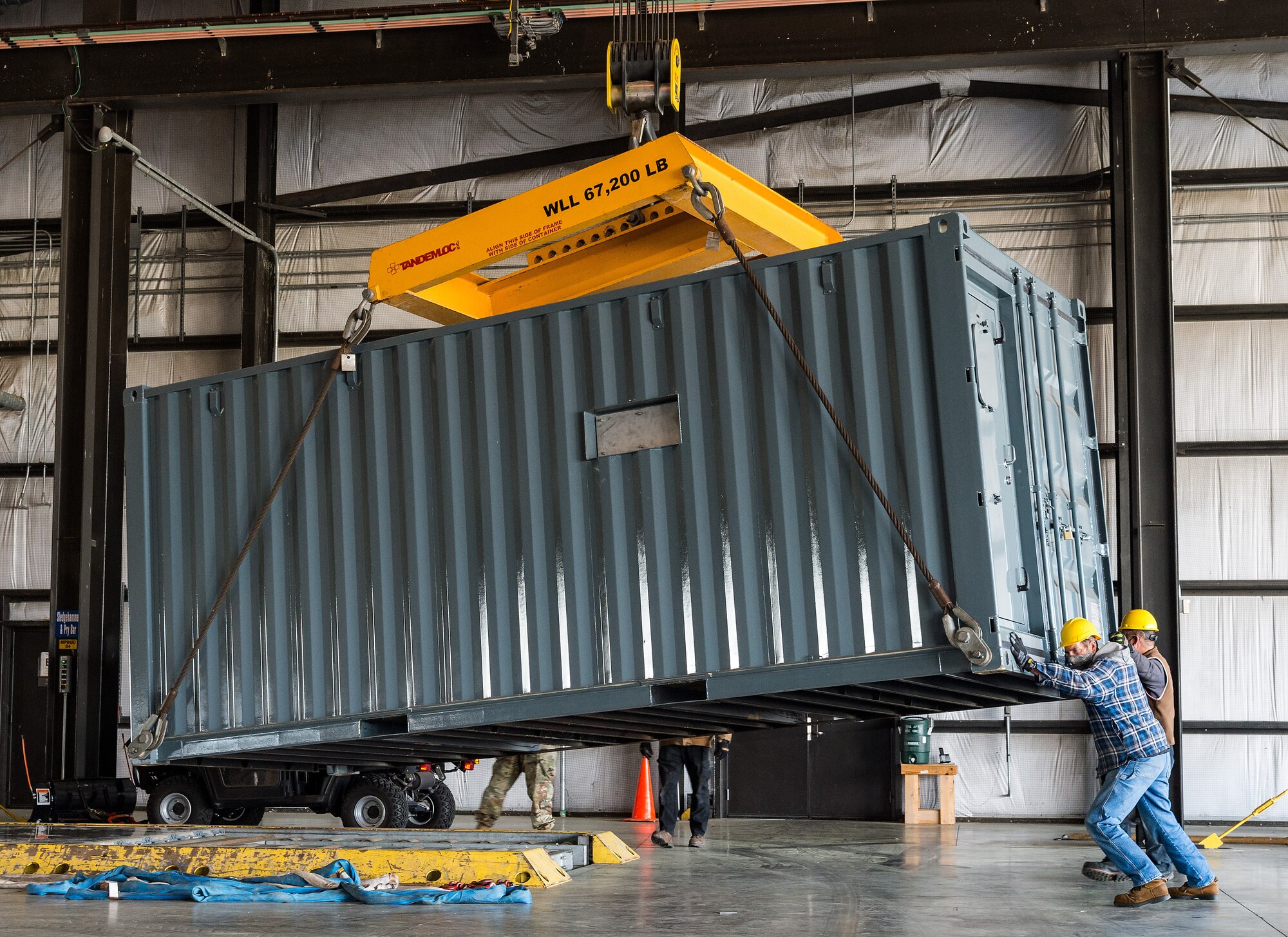 Members of the 436th Aerial Port Squadron move cargo onto pallets at Dover Air Force Base, Delaware, April 22, 2021. The 436th APS's primary mission is to provide airlift support for the movement of cargo, mail and passengers to support global operations. (U.S. Air Force photo by Roland Balik)
