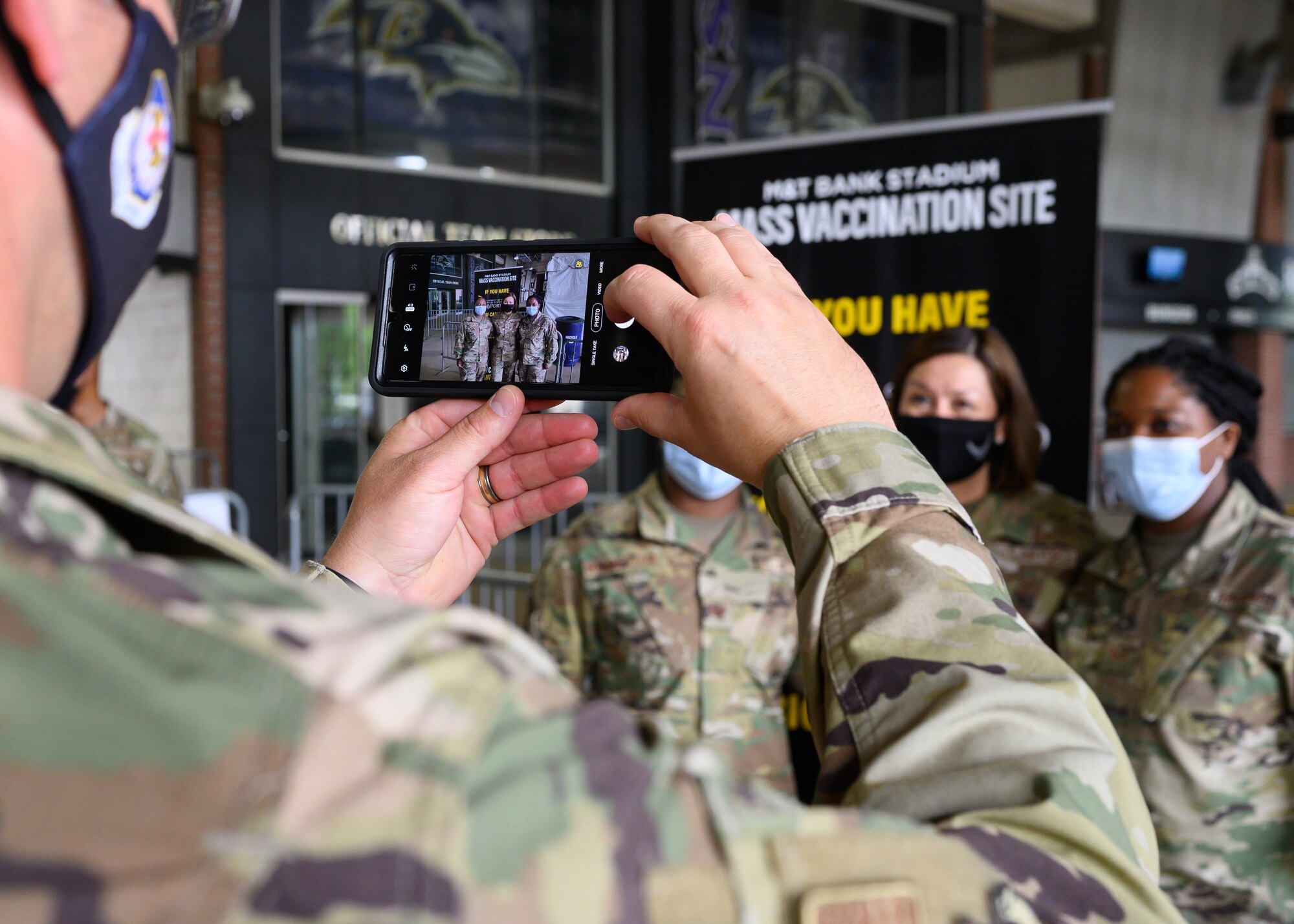 Chief Master Sgt. Paul Muggli, command chief for the 175th Wing, captures a photo of Chief Master Sgt. of the Air Force JoAnne S. Bass with 175th Wing Airmen at the mass vaccination at M&T Bank Stadium, Baltimore, on May 3, 2021.