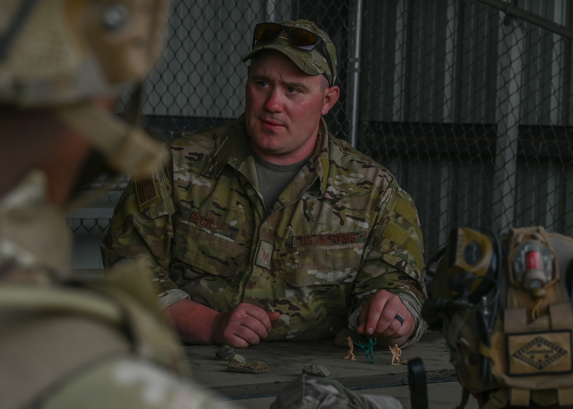 A U.S. Air Force tactical air control party Airman with the 5th Air Support Operations Squadron reviews small unit tactics with TACP Airmen at Yakima Training Center, Washington, April 28, 2021. Small unit tactics are used for the combat deployment of platoons in a particular strategic and logistic environment. (U.S. Air Force photo by Airman 1st Class Callie Norton)