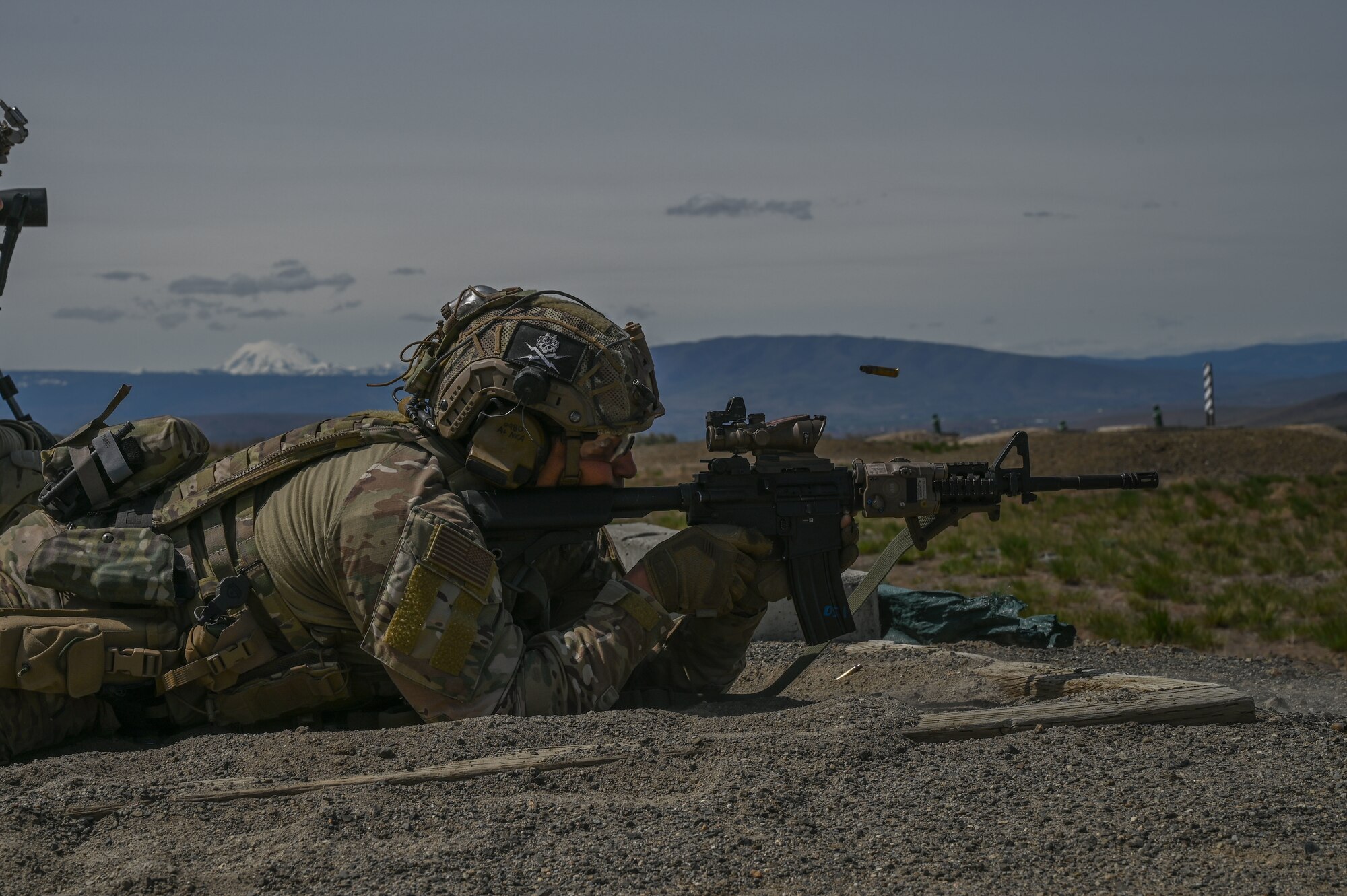 A U.S. Air Force 5th Air Support Operations Squadron tactical air control party Airman fires an M4 weapon system at Yakima Training Center, Washington, April 27, 2021. The 5th ASOS held a week-long field training exercise to become more proficient in infiltration and exfiltration, small arms marksmanship, heavy weapons utilization, small unit tactics, and force on force full mission profiles in order to meet changing tactical requirements and advance ground skill sets to meet varying mission requirements. (U.S. Air Force photo by Airman 1st Class Callie Norton)
