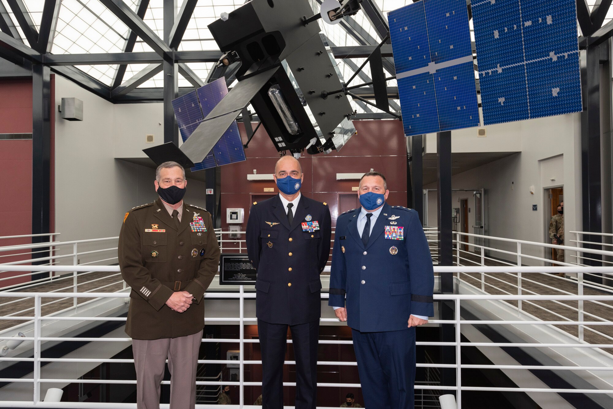 U.S. Army general, French Air Force general and U.S. Air Force general pose for a photo at U.S. Space Command headquarters.