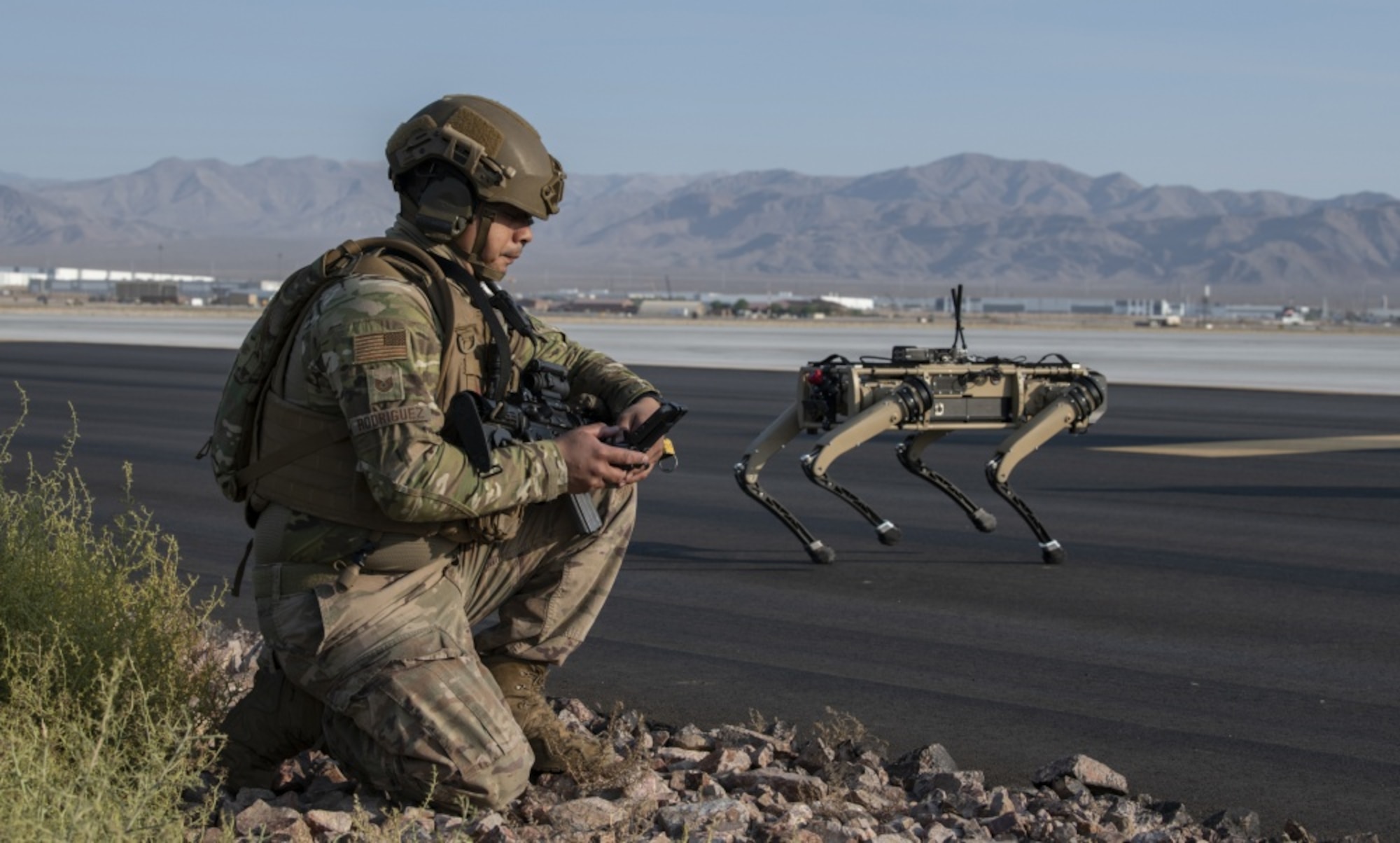 Tech. Sgt. John Rodiguez, 321st Contingency Response Squadron security team, provides operates a Ghost Robotics Vision 60 prototype at a simulated base during the second Advanced Battle Management System On-Ramp exercise at Nellis Air Force Base, Nevada, in Sept. 2020. These ‘dogs’ are semi-autonomous robots equipped with artificial intelligence to (U.S. Air Force photo by Tech. Sgt. Cory D. Payne)