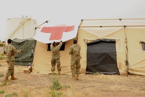 Image of Airmen setting up a tent.