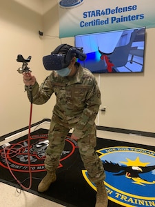 Staff Sgt. Julia Reyna, 318th Training Squadron Structures and Corrosion Instructor, uses the paint simulator during a demonstration at Joint Base San Antonio, Lackland, Texas, April 28, 2021. The newly acquired software allows mobile training teams to travel with the equipment and provide instruction to partner nation members with real-time results while eliminating expenses. (U.S. Air Force photo by Vanessa R. Adame)