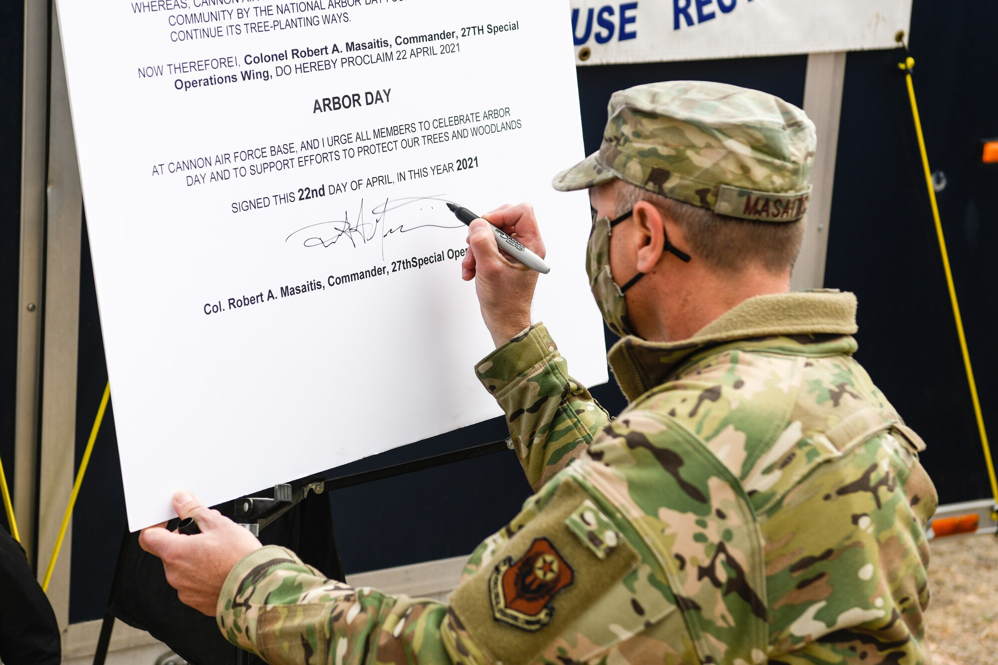 The 27th Special Operations Wing commander, Col. Robert A. Masaitis, signs into effect Arbor Day ceremony at Cannon Air Force Base, N.M., on April 26, 2021. The tree planting ceremony highlights the goal of building a sustainable future. (U.S. Air Force photo by Senior Airman Marcel Williams)