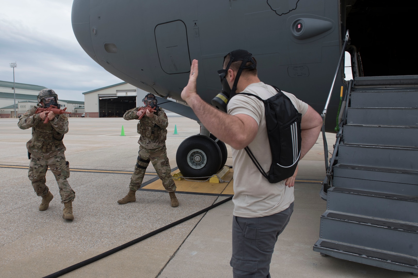 U.S. Air Force Senior Master Sgt. Nate Smith, right, a loadmaster and flight safety non-commissioned officer for the 167th Airlift Wing, plays the role of an aircraft hijacker as Staff Sgt. Bradley Knotts and Staff Sgt. Ryan Jenkins, with the 167th Security Forces, maneuver to apprehend him during a Counter CBRN (Chemical, Biological, Radiological, and Nuclear) All-Hazard Management Response, or CAMR, exercise at Shepherd Field, Martinsburg, West Virginia, April 30, 2021. CAMR is a hybrid program of classroom lecture, discussion and tabletop exercises that culminate in a full scale emergency response exercise.