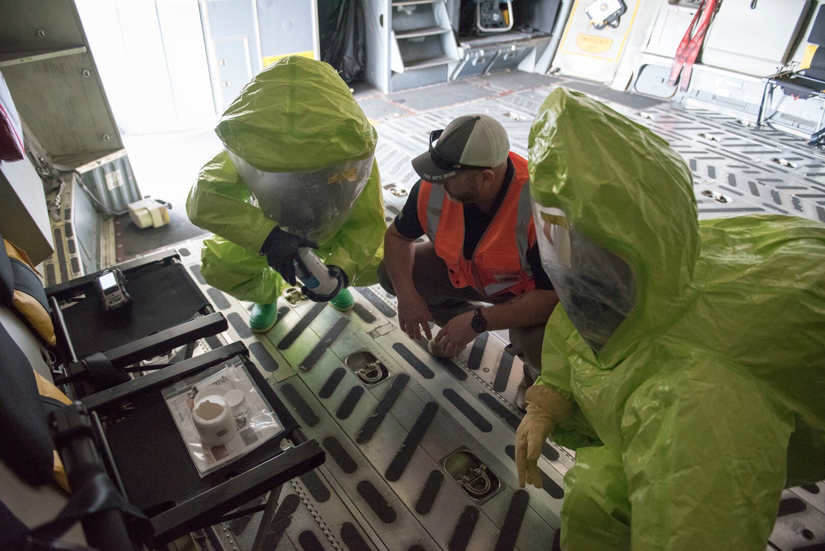 Chris Keesee, center, CBRN training project manager for Federal Resources, assists U.S. Air Force 1st Lt Samuel Gerard, with 167th bioenvironmental engineering, and Staff Sgt. Austin Lloyd, 167th Airlift Wing firefighter, as they test an unknown substance on a C-17 Globemaster III aircraft as part of a Counter CBRN (Chemical, Biological, Radiological, and Nuclear) All-Hazard Management Response, or CAMR, exercise at the 167th AW, Shepherd Field, Martinsburg, West Virginia, April 30, 2021. CAMR is a hybrid program of classroom lecture, discussion and tabletop exercises that culminate in a full scale emergency response exercise.