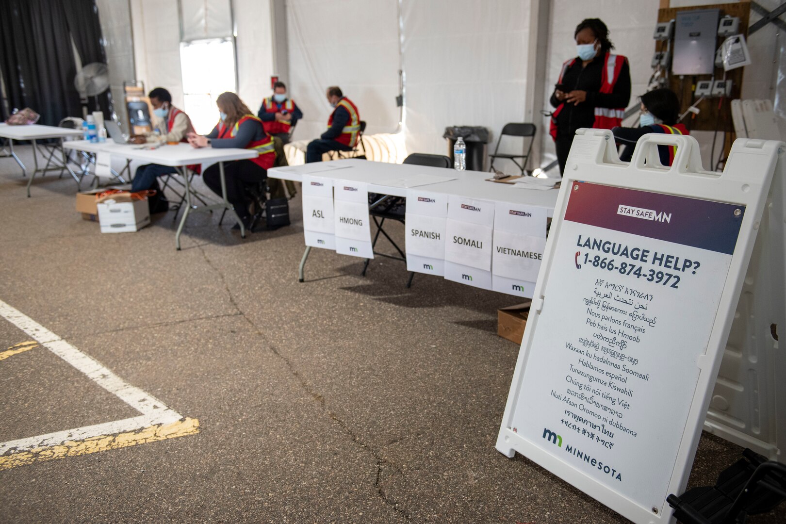Language translators assist the community at a community vaccination center.