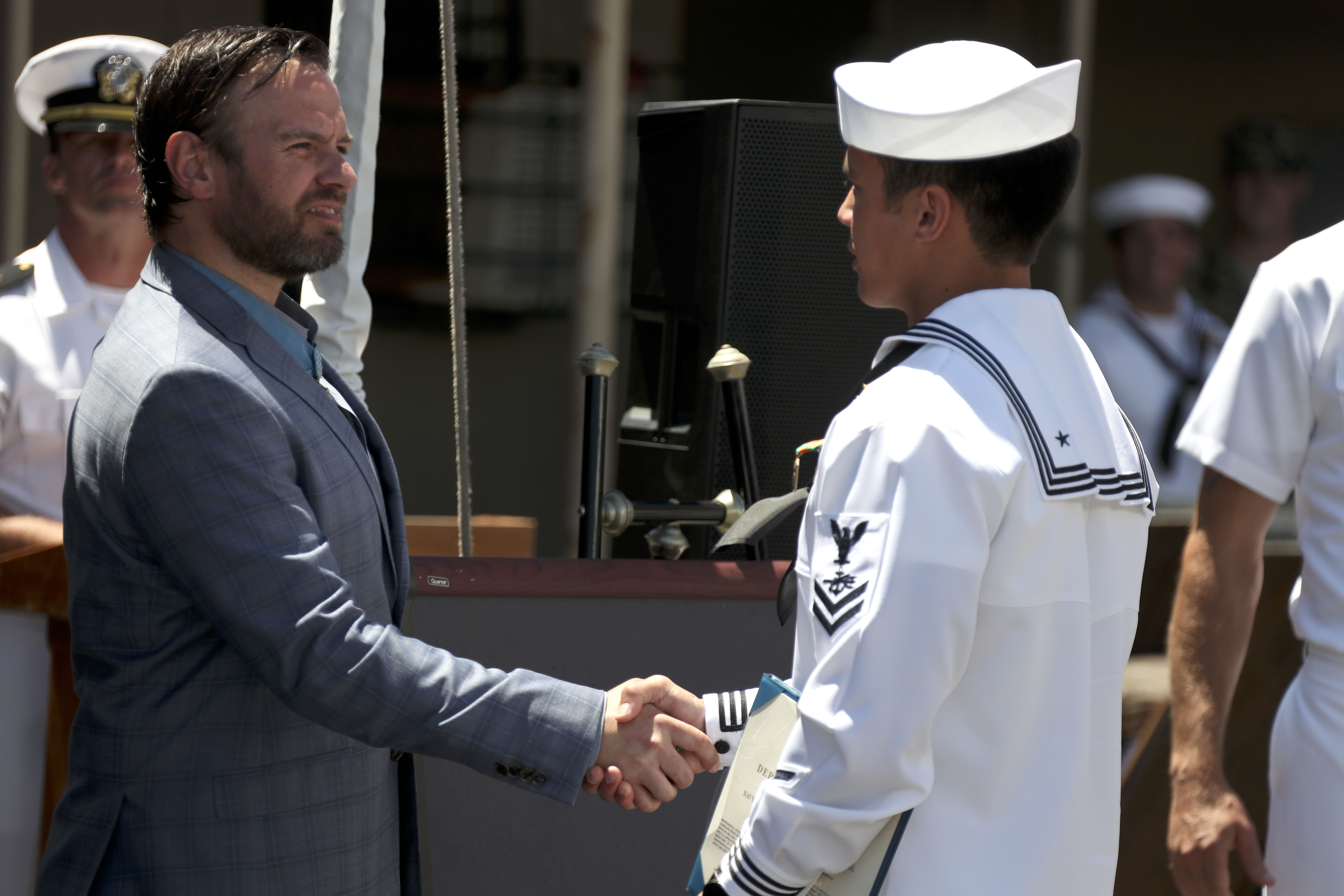Medal of Honor recipient retired Master Chief Special Warfare Operator (SEAL) Edward C. Byers Jr., guest speaker during SEAL Qualification Training Class 342’s graduation, congratulates the class honor man.