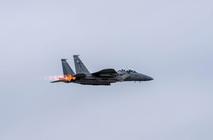 F-15EX flies over mountains