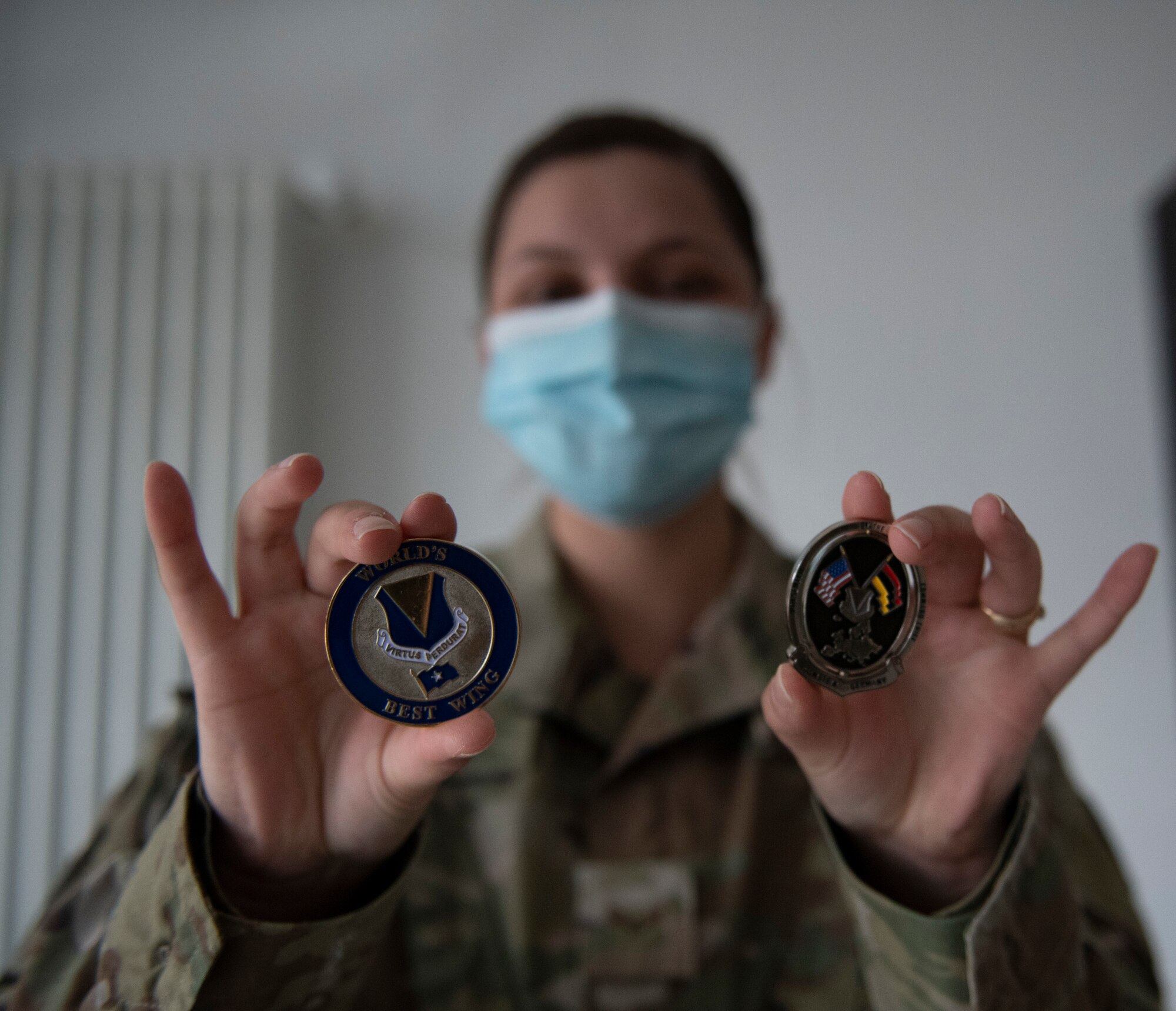 Female Airman shows off challenge coins.