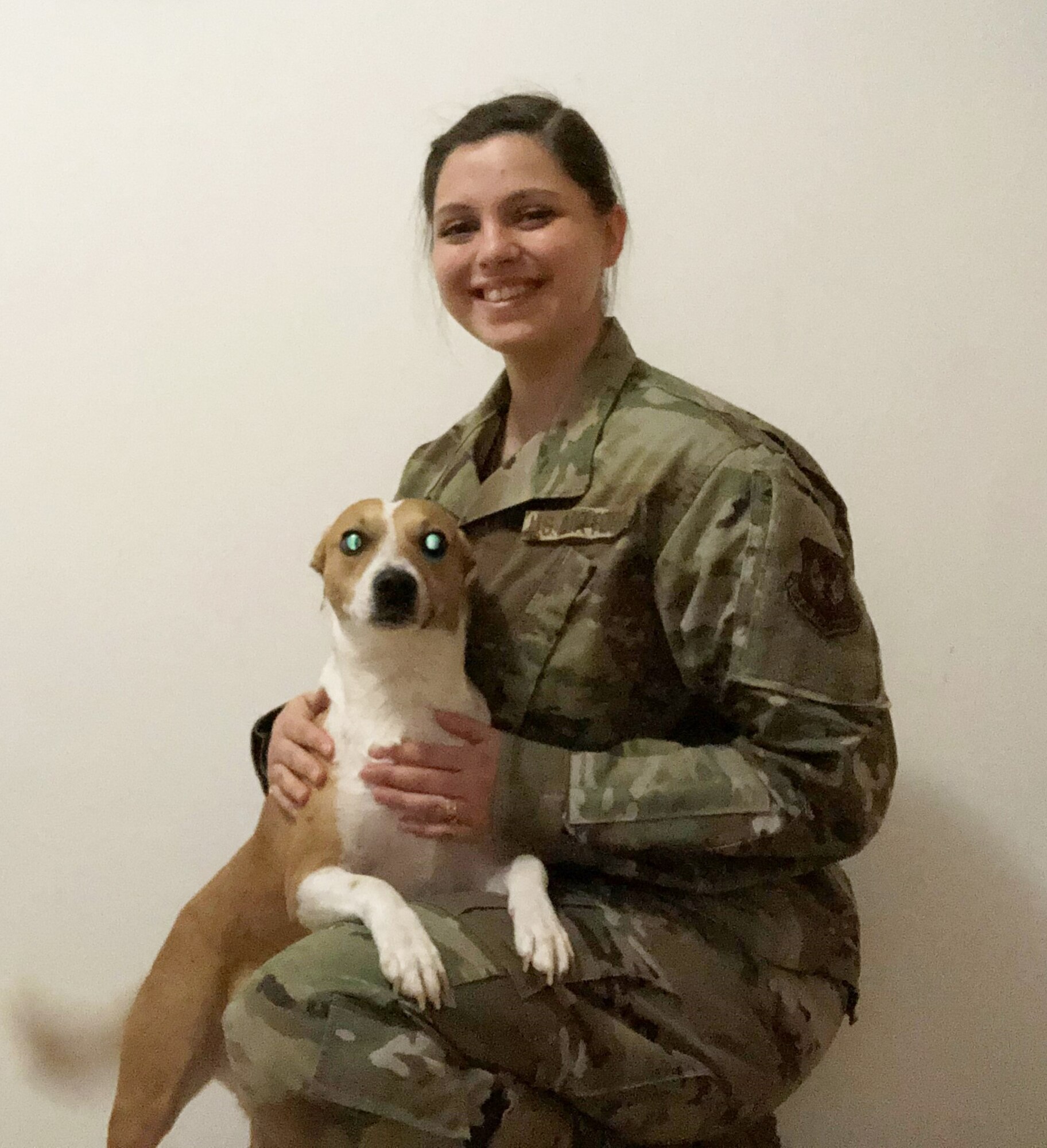 Female Airman poses with her dog.